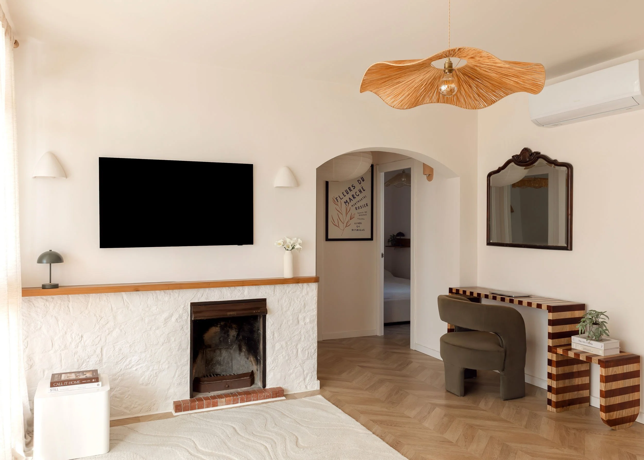 Living area with arched doorway and natural light