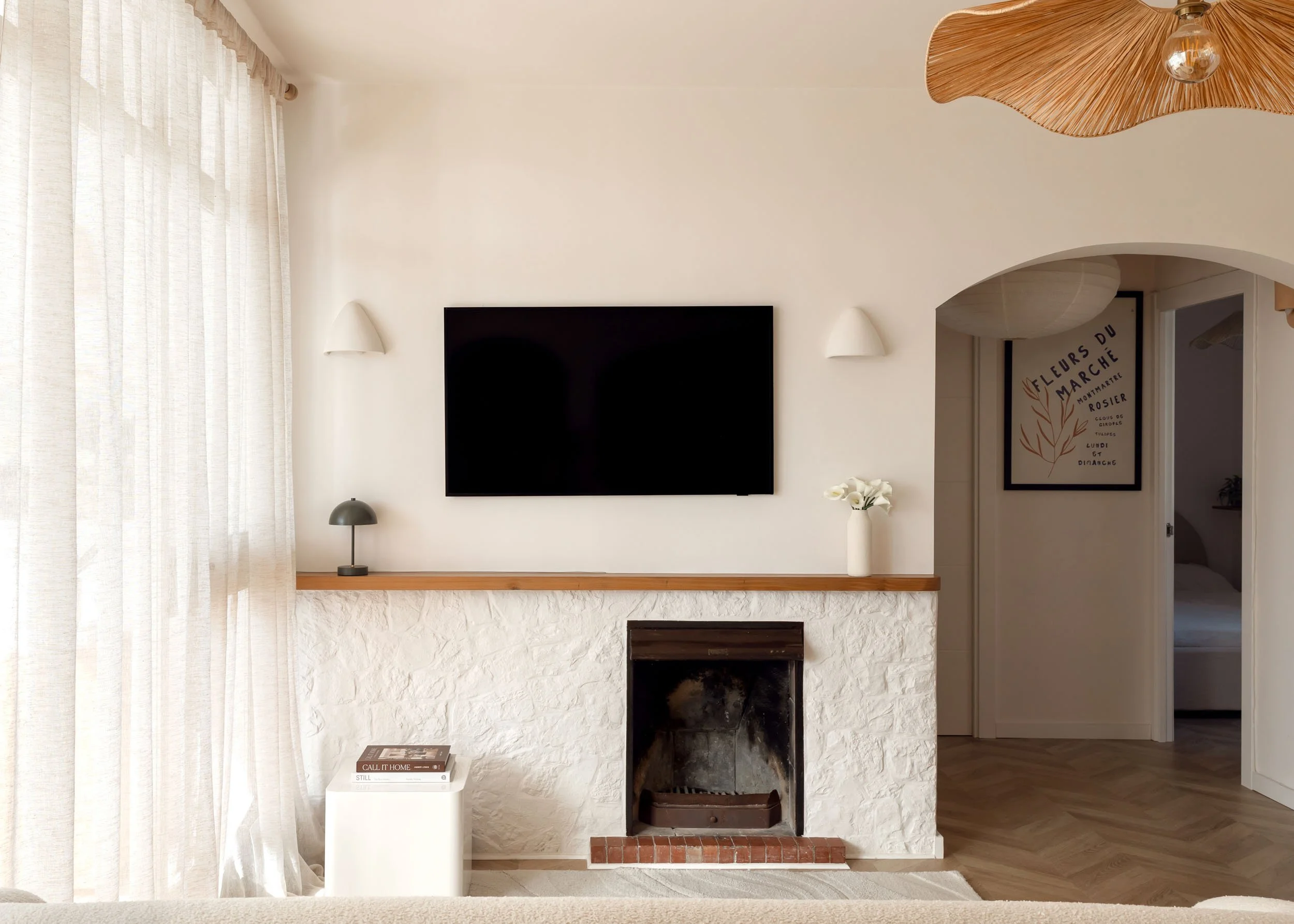 Minimal living room with textured fireplace and neutral tones
