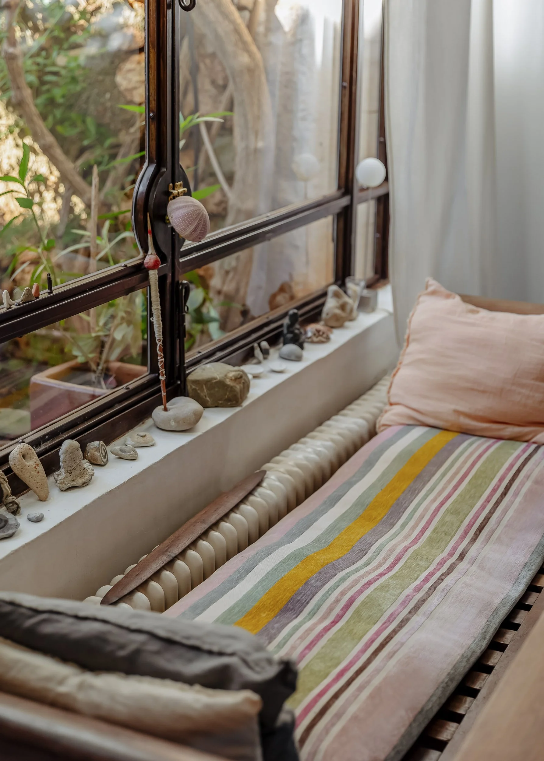 Window daybed with natural textiles and soft Mediterranean light