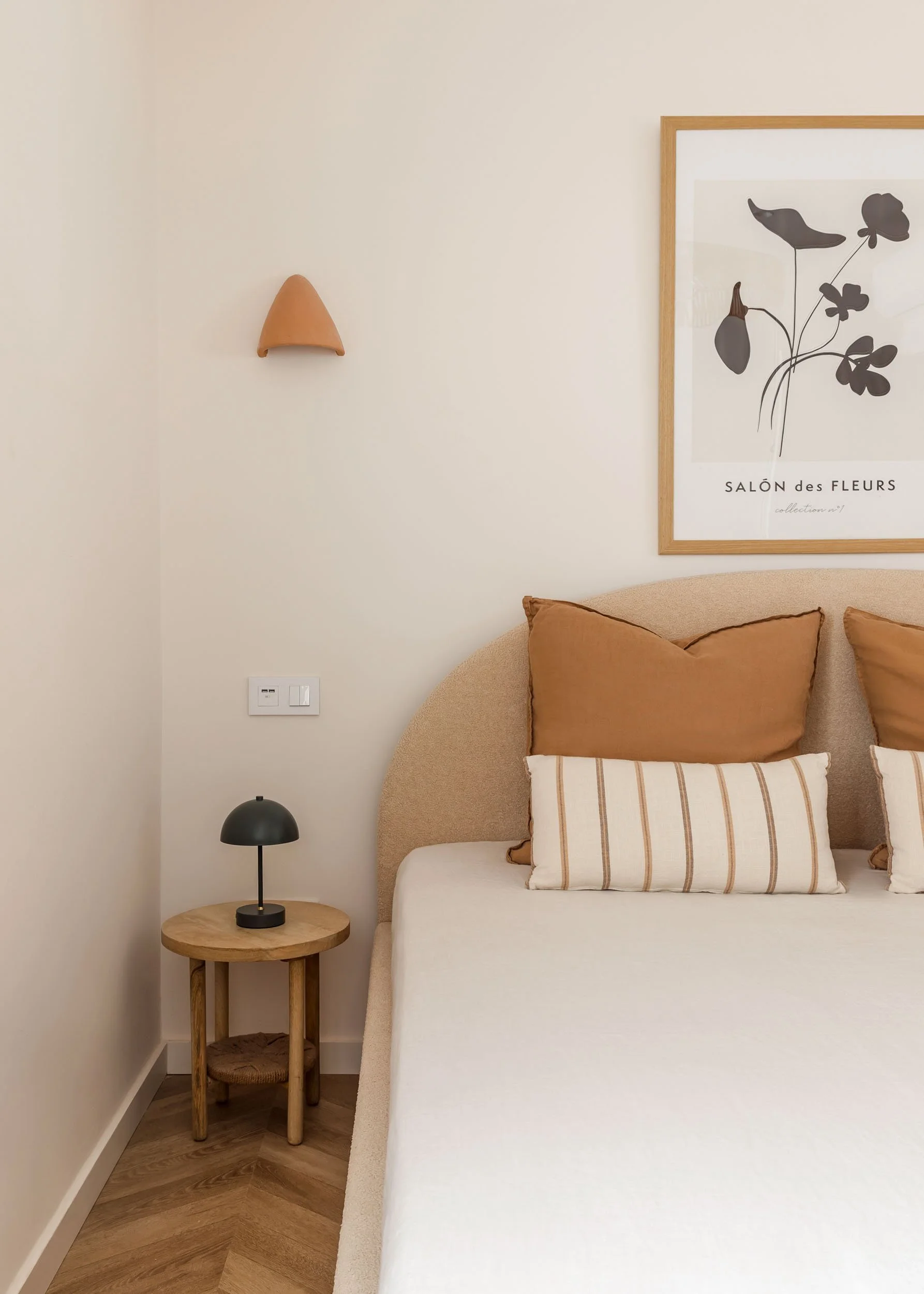 Bedroom corner with textured headboard and warm neutral tones