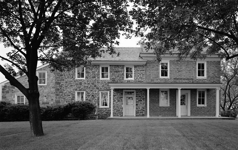 Stone farmhouse with double doors and porch