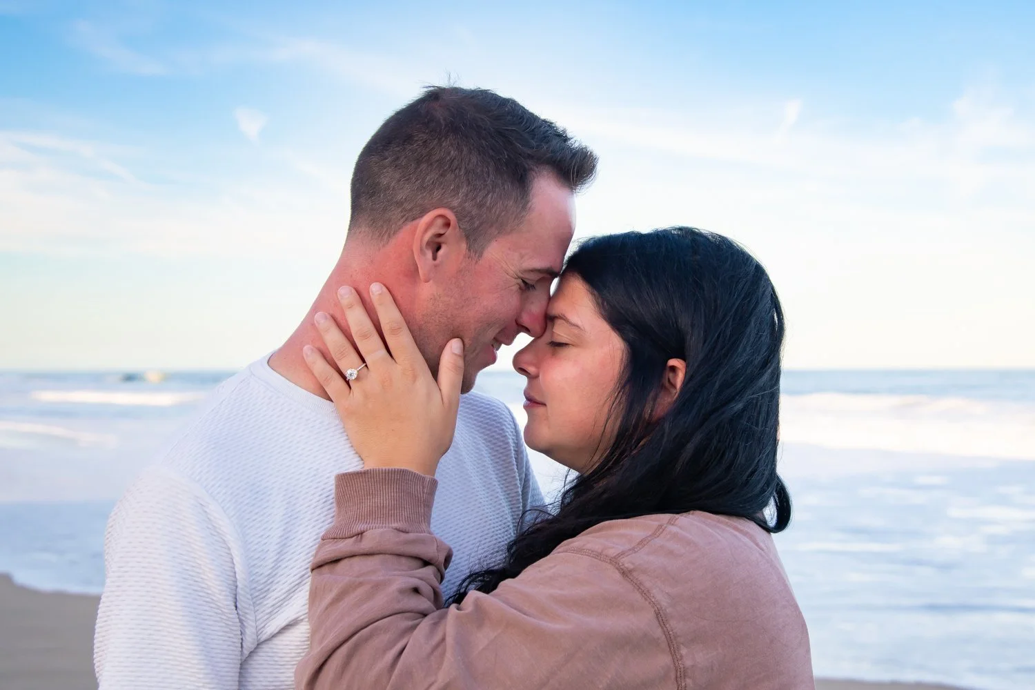 Surprise engagement photography session on the beach in Ocean City, Maryland by Rayne Photography