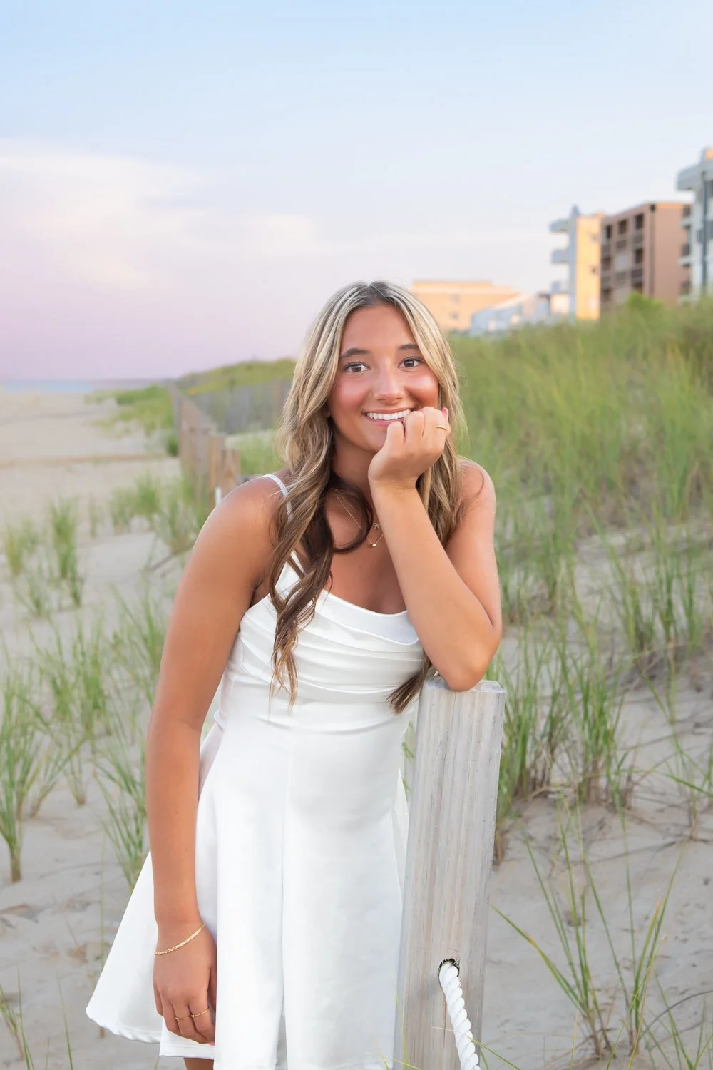 Golden hour senior portraits captured by Rayne Photography on the beach in OC MD