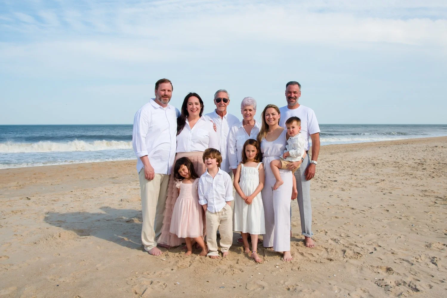 Professional family portraits captured on the beach by Rayne Photography in Bethany Beach, Delaware