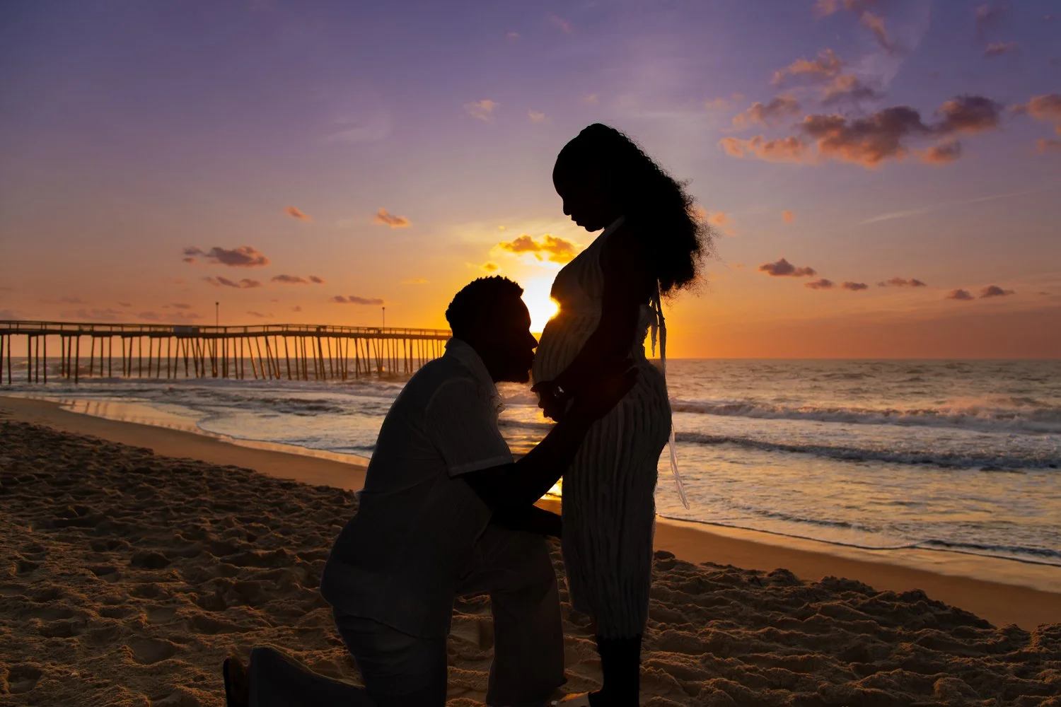 Sunrise maternity photo session by Rayne Photography at the Ocean City, MD Inlet Pier and Boardwalk