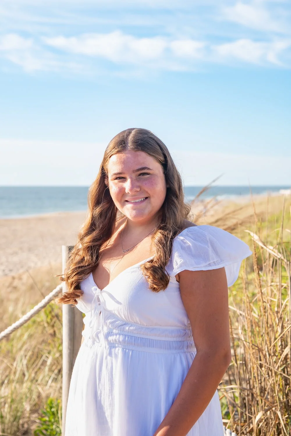 Senior portrait photo session on the beach by the dunes at Bethany Beach, DE with Rayne Photography