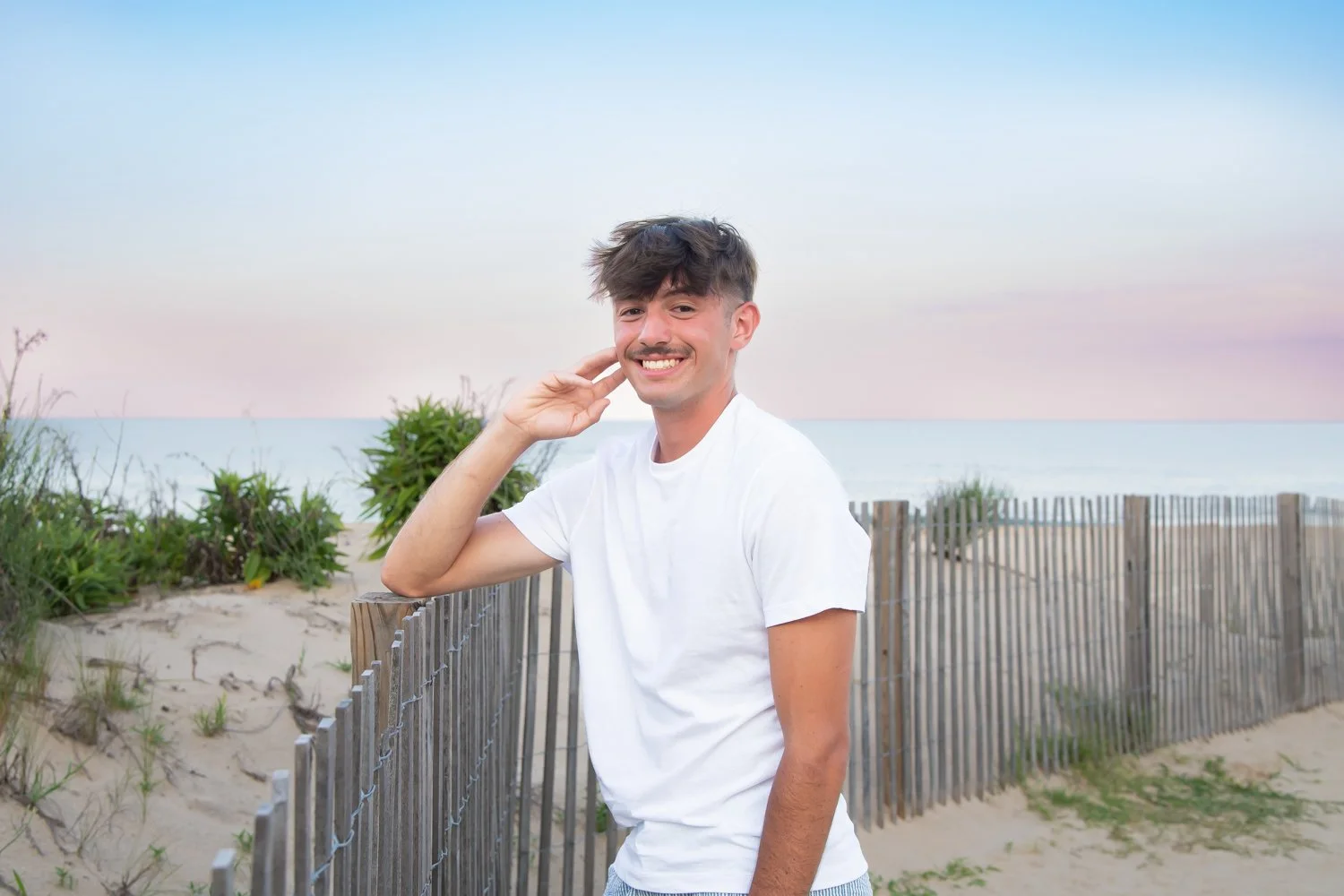 Golden hour senior portraits captured by Rayne Photography on the beach in Ocean City, MD