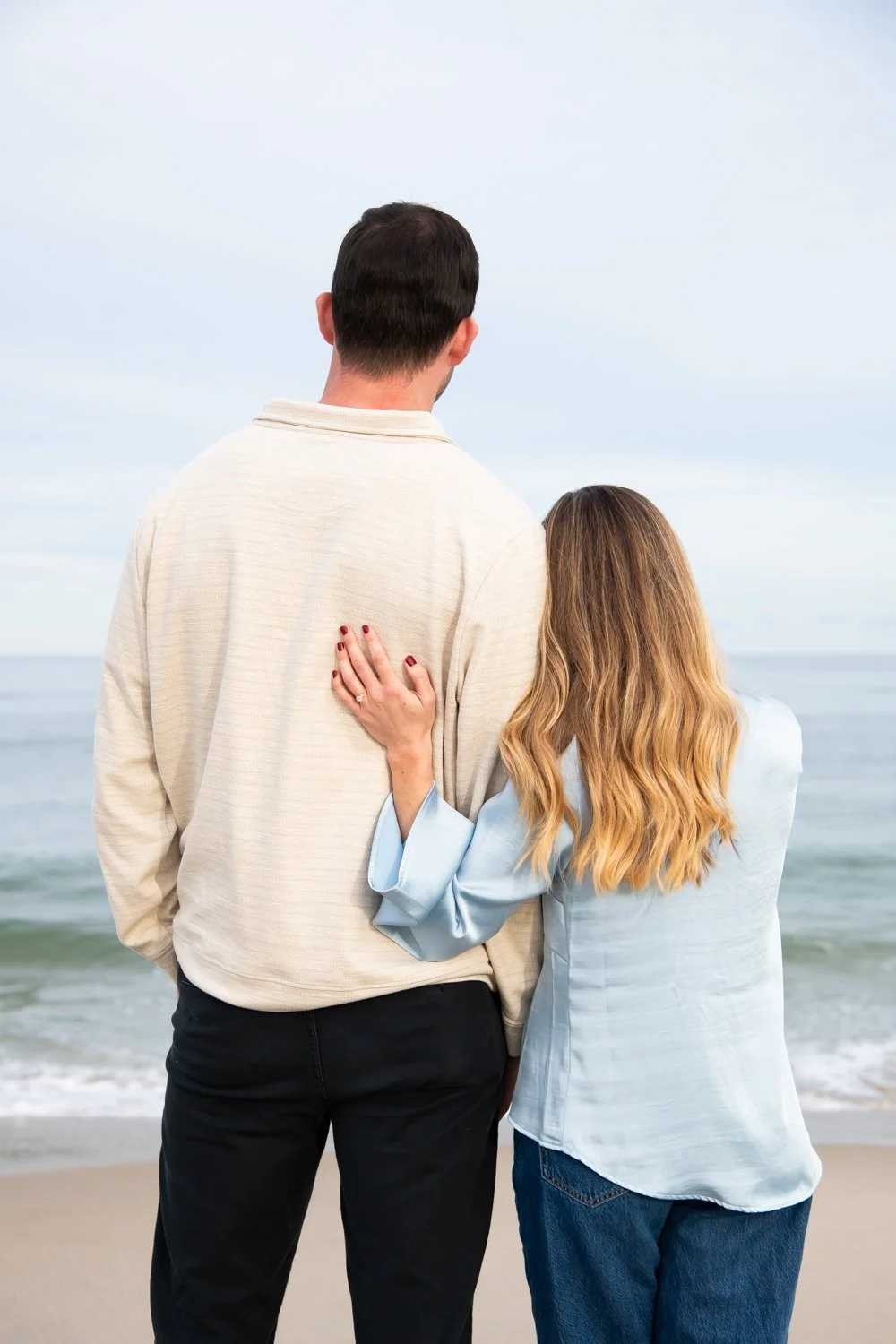 Surprise engagement photo session on the beach in Rehoboth Beach, DE by Rayne Photography