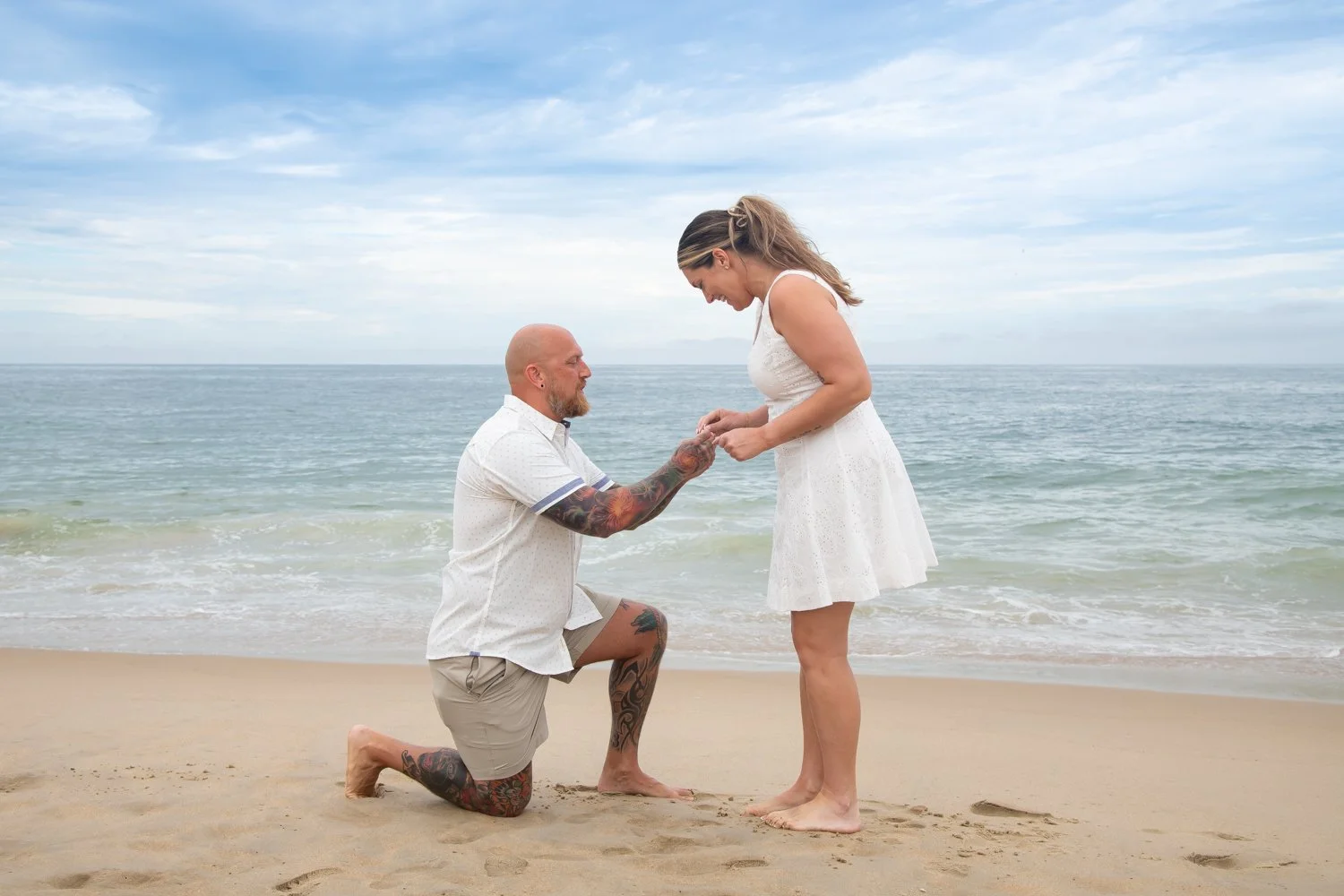 Surprise engagement sessions captured on the beach in Bethany Beach by Rayne Photography