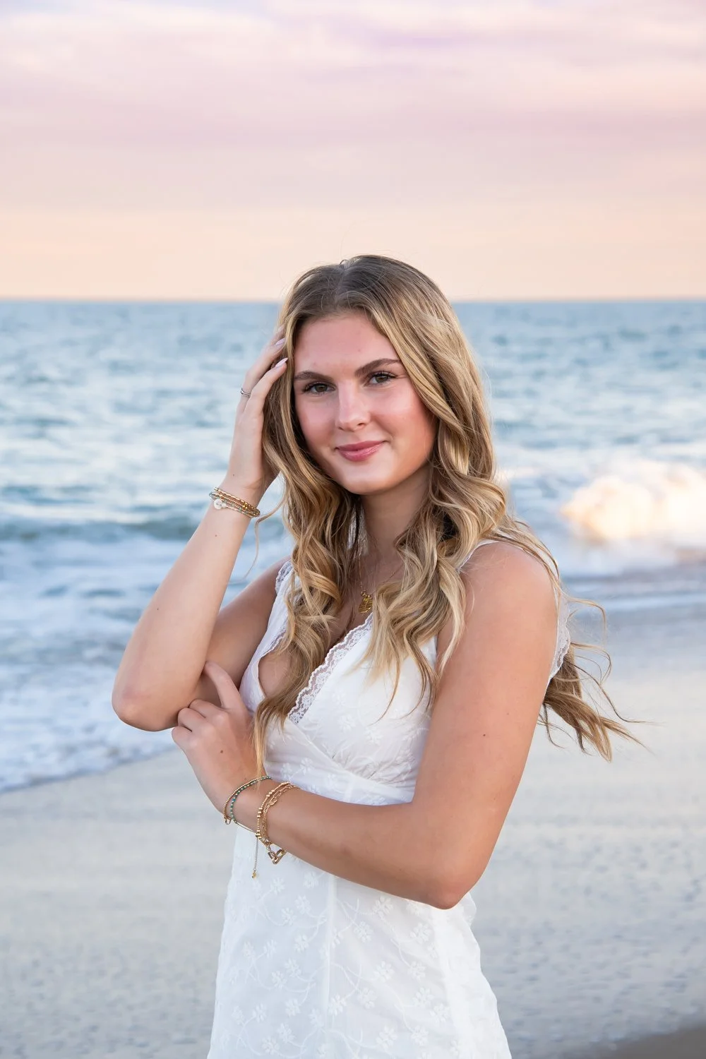 Sunset senior portraits captured by Rayne Photography on the beach in OC MD