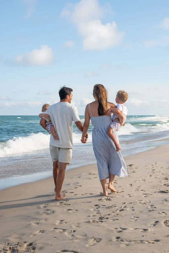Professional family portraits captured on the beach by Rayne Photography