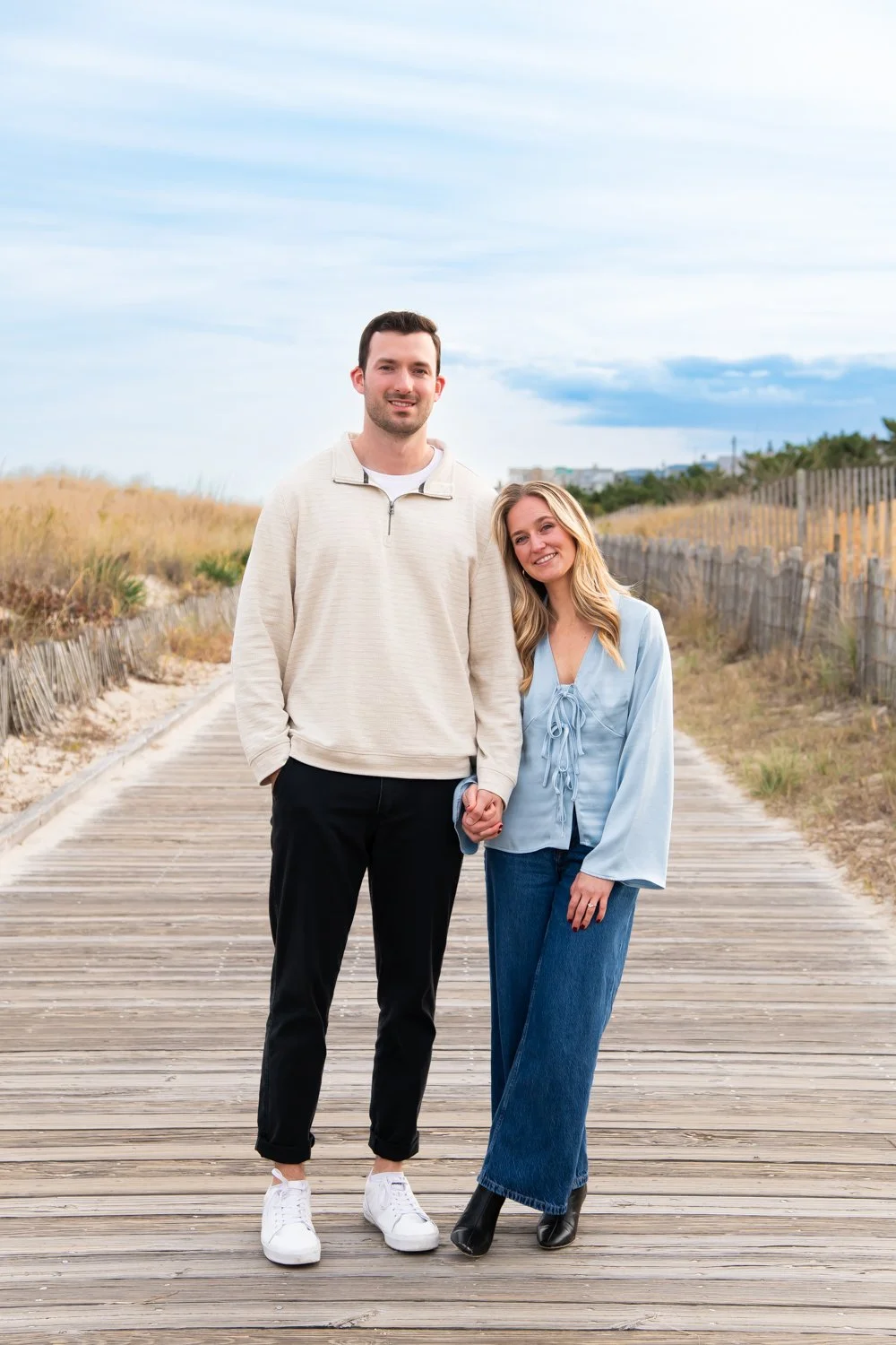 Engagement photo session on the boardwalk at Rehoboth Beach, DE by Rayne Photography