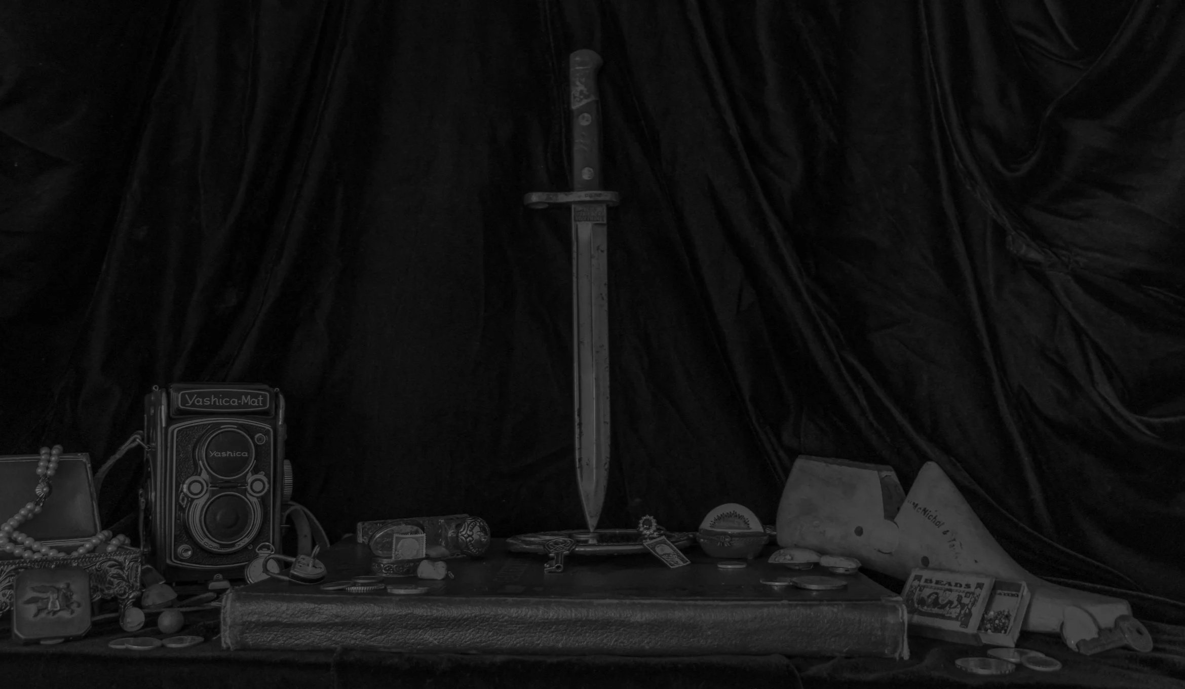 A dark, black and grey ink image of a gothic sword, similar to some of the tattoo designs offered at this local tattoo shop in Eau Claire, Wisconsin