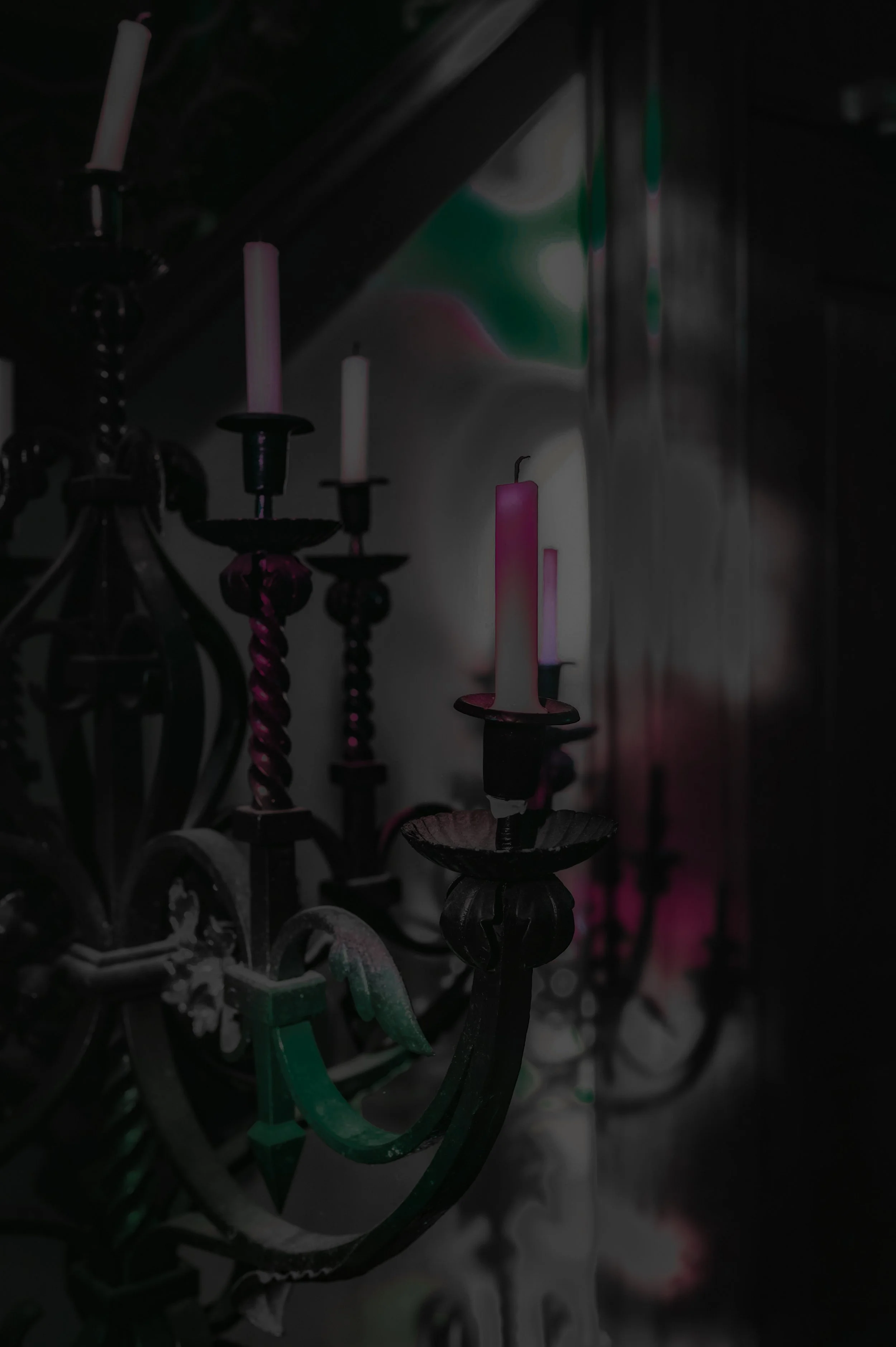 a cool punk, set of candles in this tattoo shops brand colors, in a gothic witchy setting that is comfortable and queer friendly
