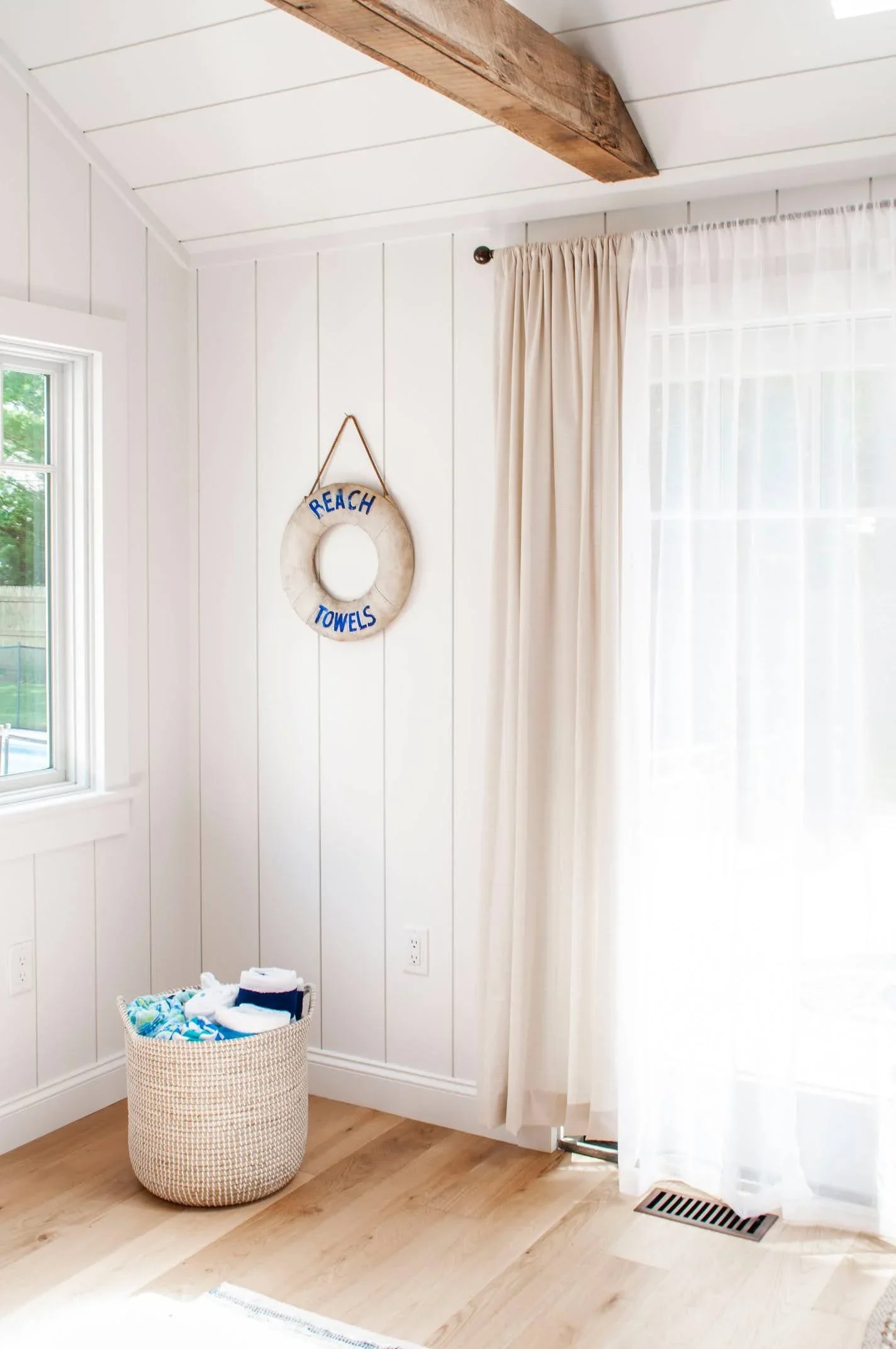 Sea View Builders designed this Cape Cod living space with custom shiplap walls, coastal-inspired accents, and bright natural light.