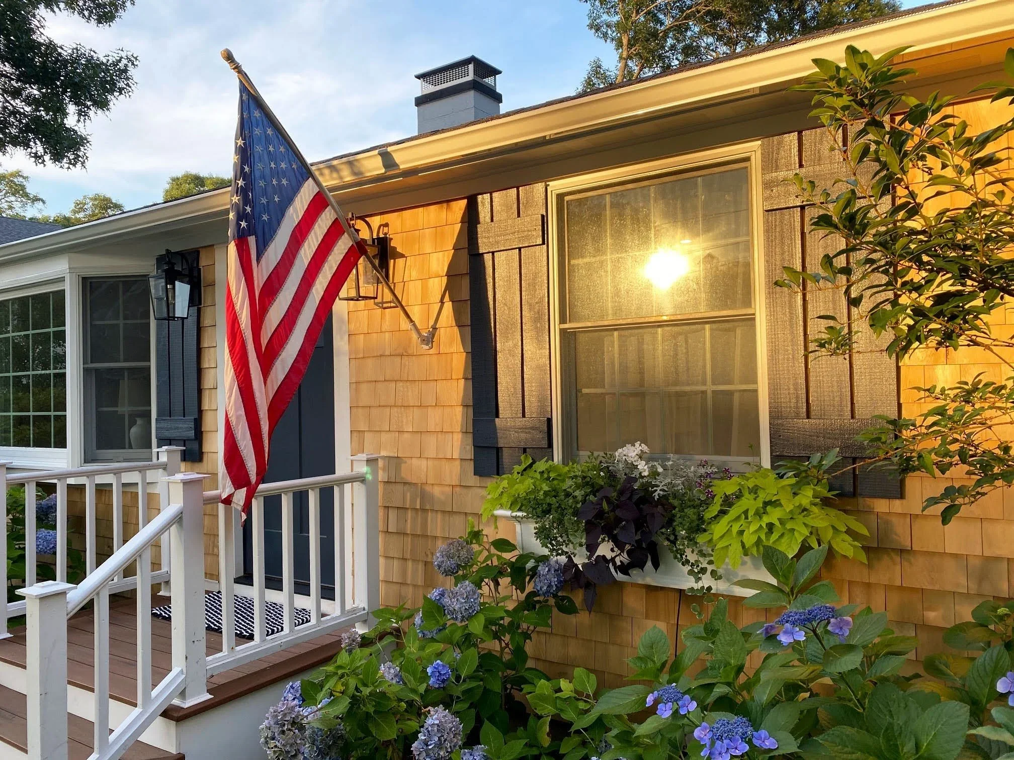 Sea View Builders designed this custom Cape Cod home with cedar shingles, traditional shutters, landscaped gardens, and timeless coastal curb appeal.