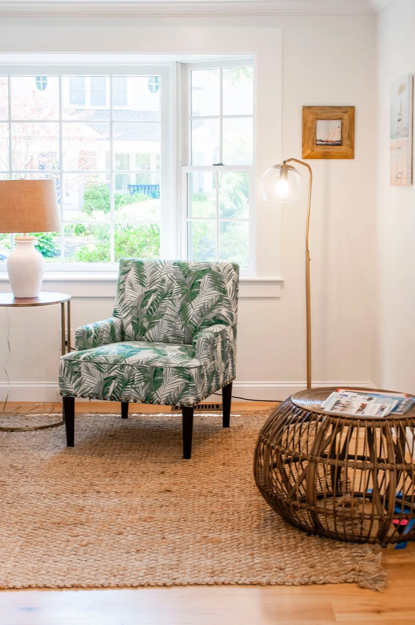 Sea View Builders designed this Cape Cod living space with abundant natural light, custom trim, woven accents, and timeless coastal interior design.