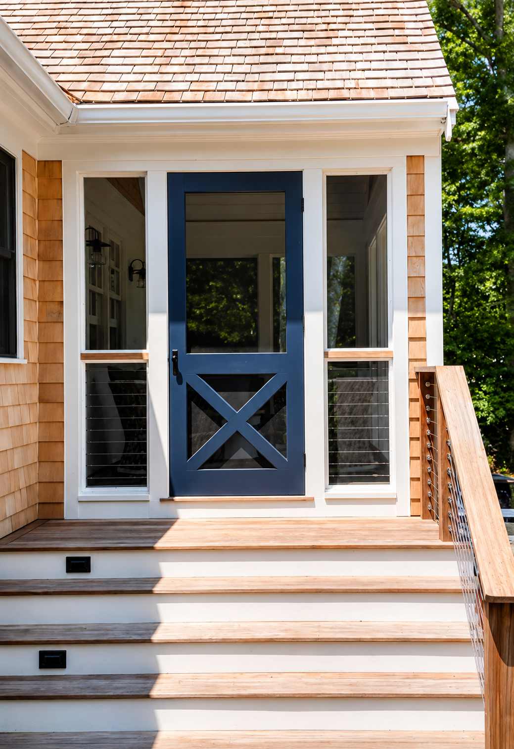 Sea View Builders crafted this Cape Cod front entrance with cedar shake siding, a custom Dutch door, and detailed exterior millwork.