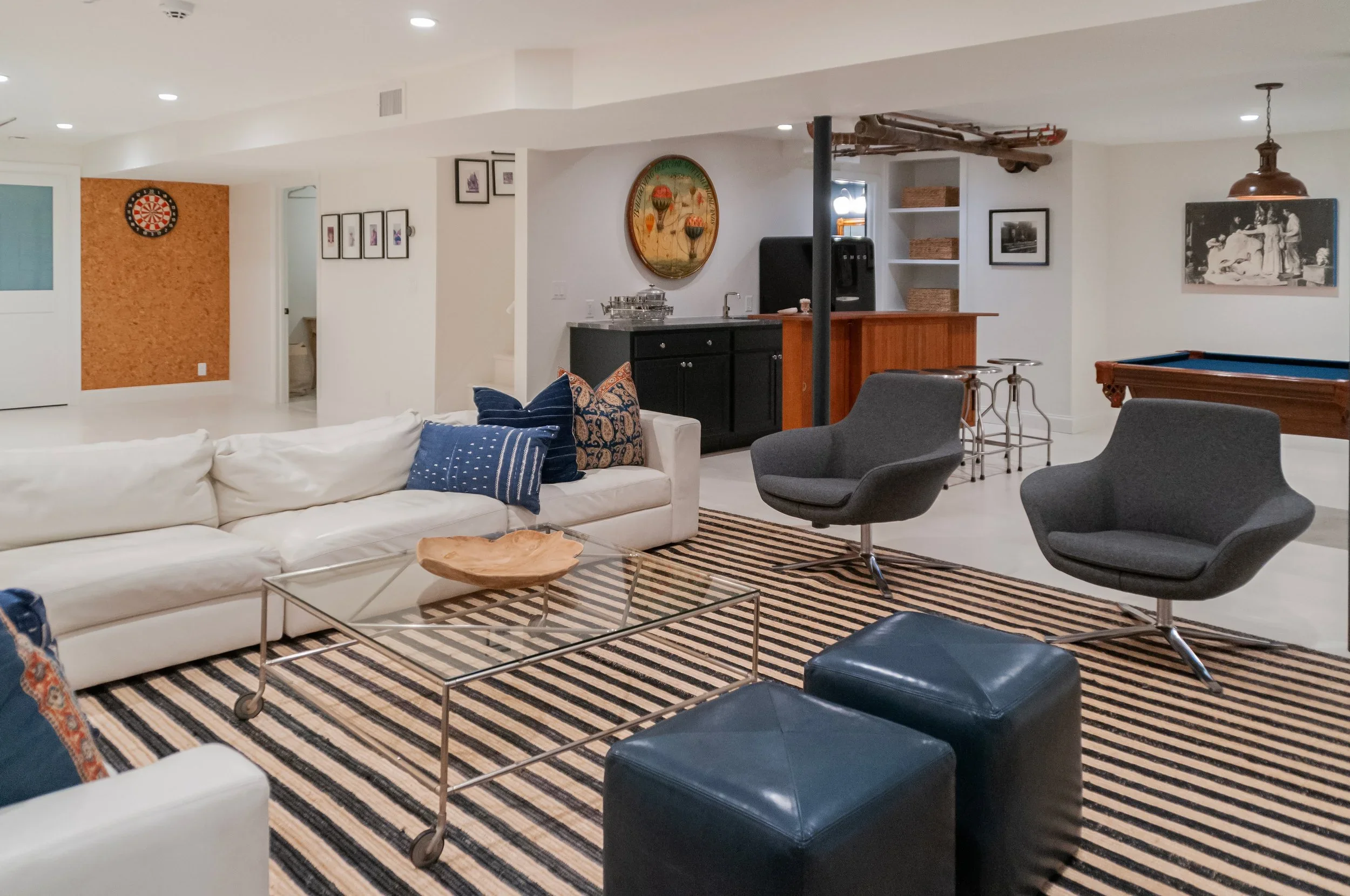 Sea View Builders transformed this Cape Cod basement with a custom wet bar, game room, media area, and built-in entertaining spaces.