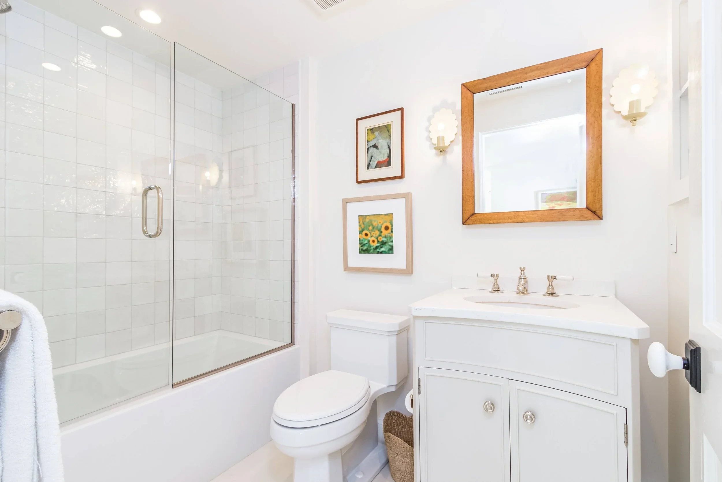 Sea View Builders designed this custom bathroom with a quartz vanity, subway tile tub surround, polished nickel fixtures, and timeless Cape Cod design.