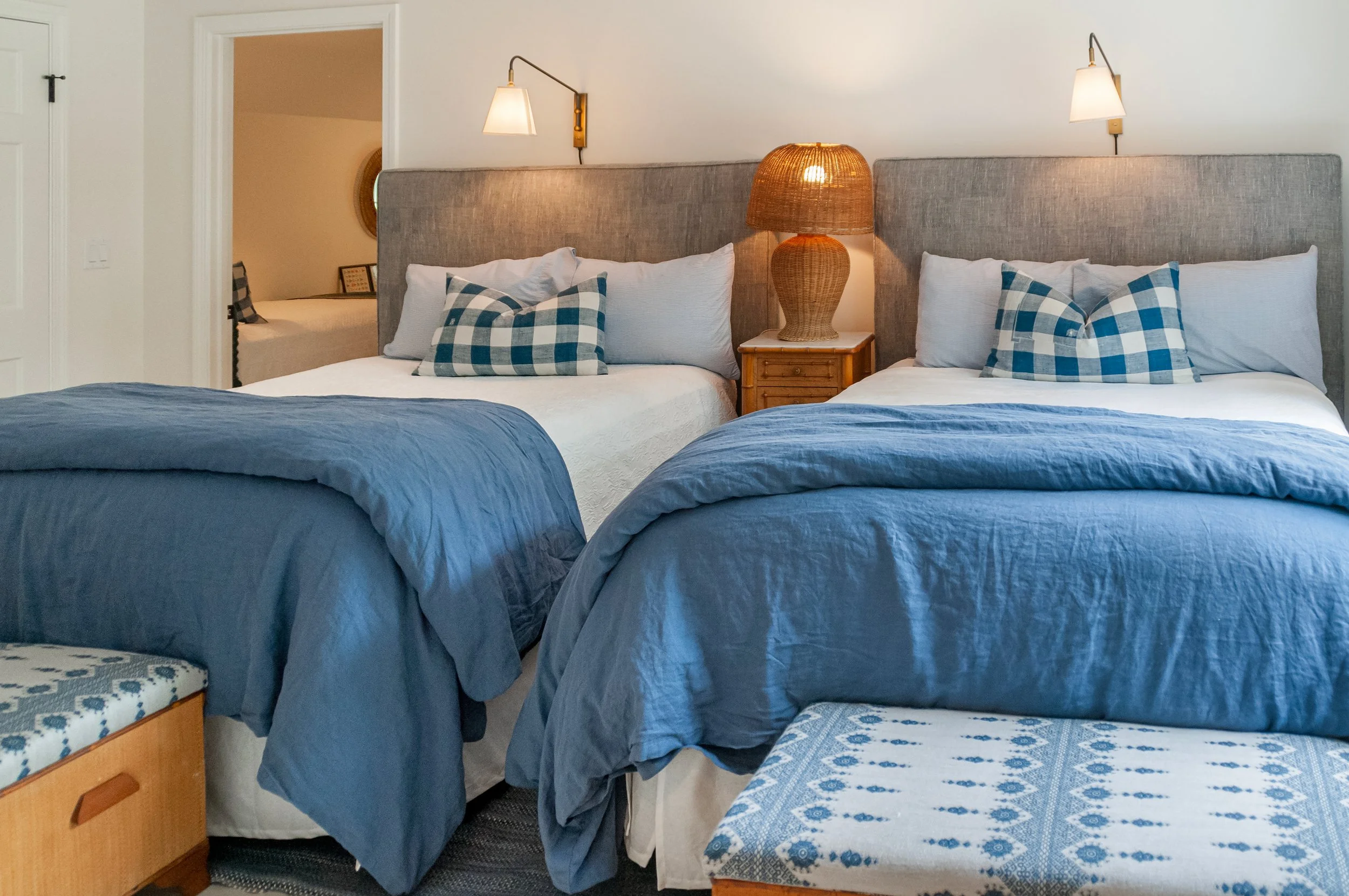 Twin-bed guest room with blue bedding, plaid pillows, and coastal bedroom design for a Cape Cod home.