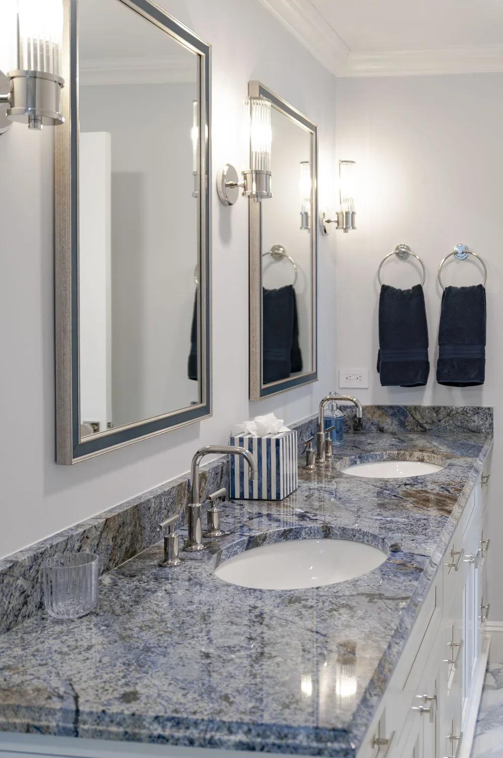 blue stone countertops and twin sinks bring custom coastal home detail to this polished Cape Cod bath.