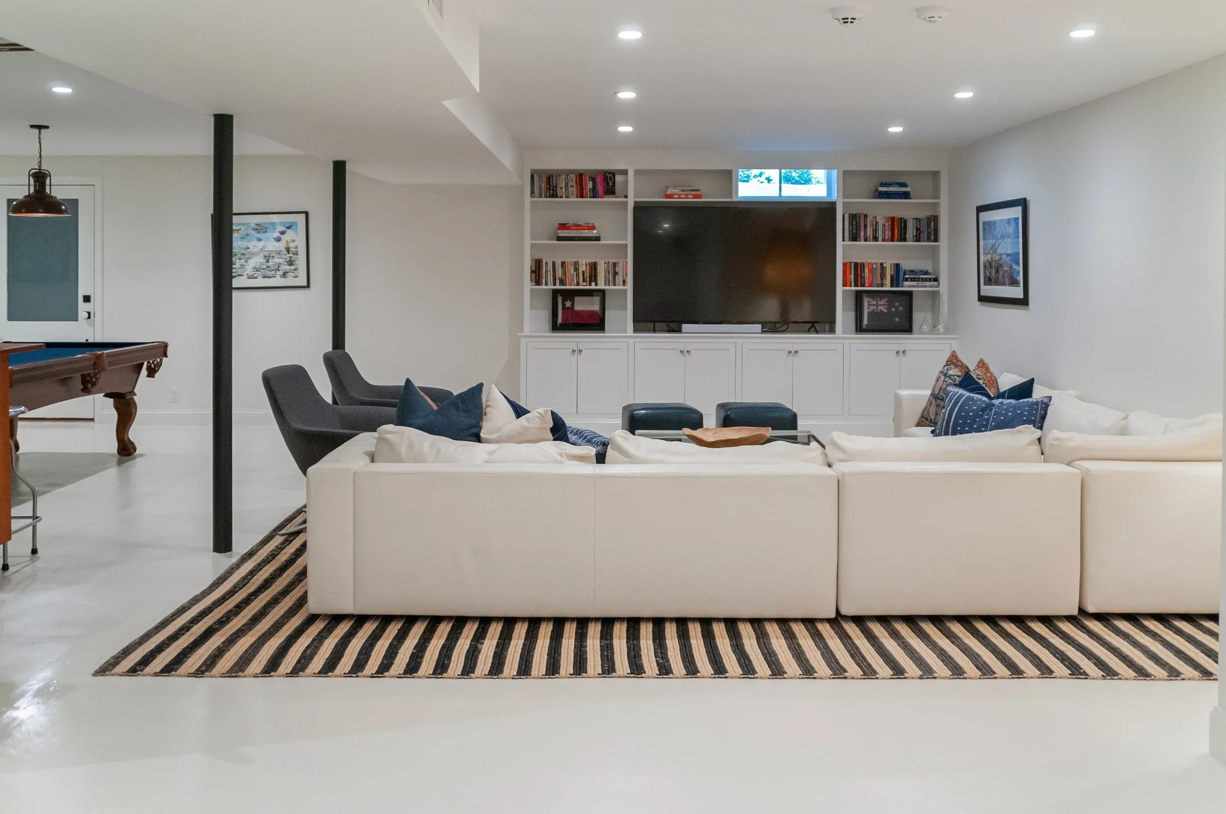 Sea View Builders designed this finished lower level with a custom entertainment center, built-in cabinetry, media room, and Cape Cod basement renovation.