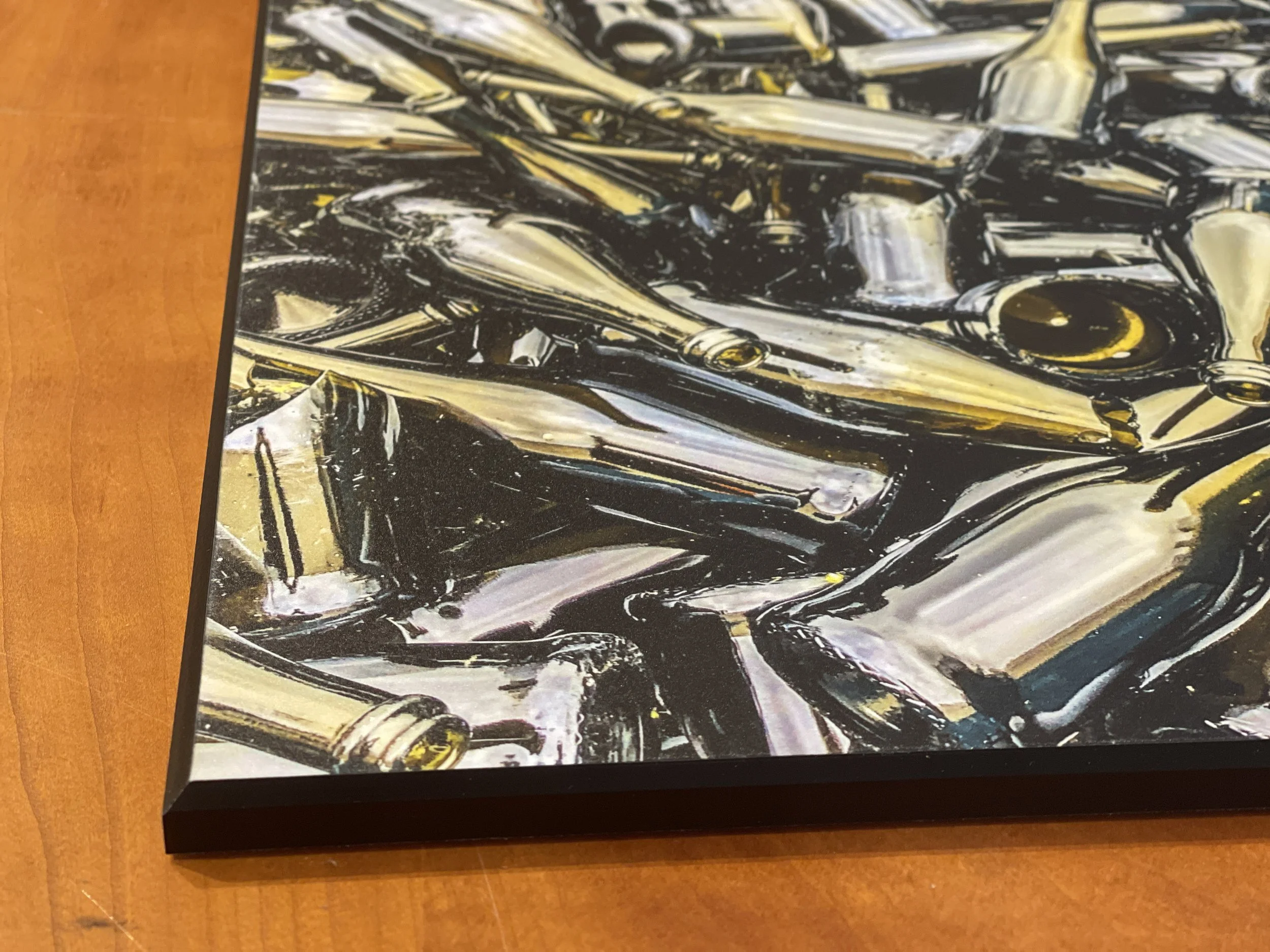 Close-up of a pile of used metal nail polish bottles on a wooden surface.