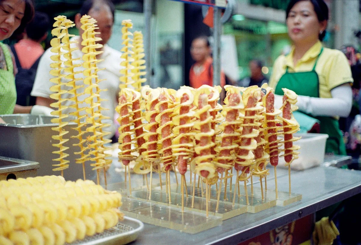 twisty hot dog with potato wrapping around it * screw * food * asia * ennis 35mm film street photography south korea seoul * 2012