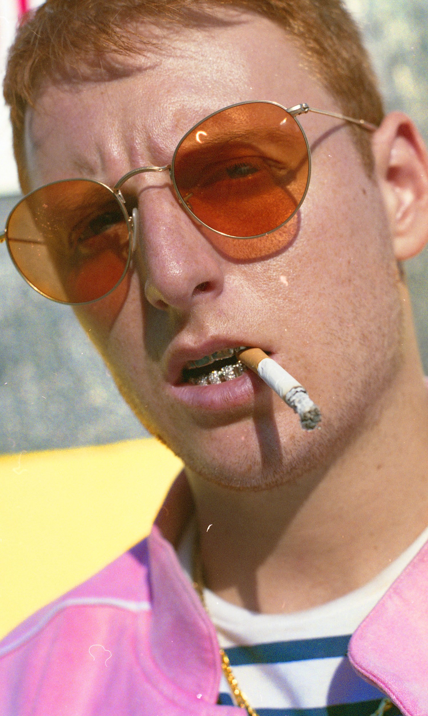 ennis 35mm film photography -Maison Raksha Grillz at Kidsuper brooklyn new york pink shirt sunglasses portrait red head-02.jpg