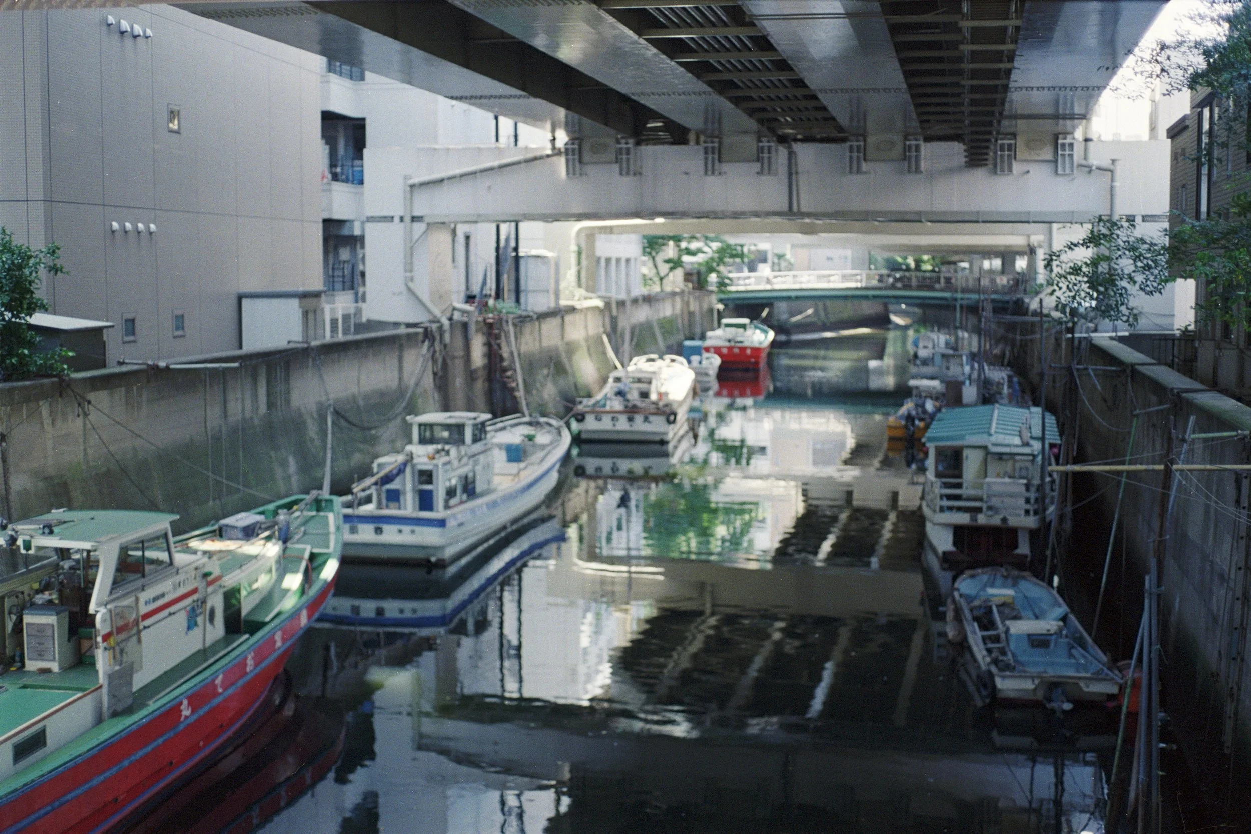 small fishing boats parked under bridge * ennis 35mm film photography japan street 2012
