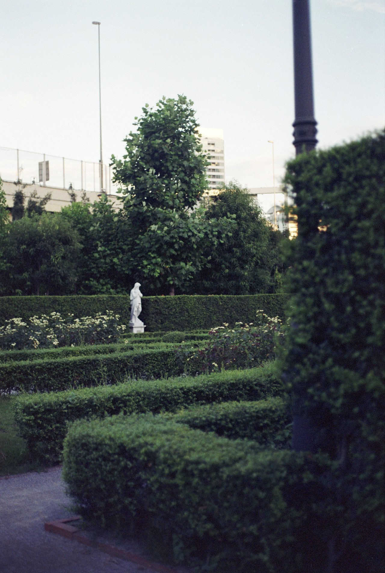 white statue in maze garden with city in background * ennis 35mm film photography japan street 2012