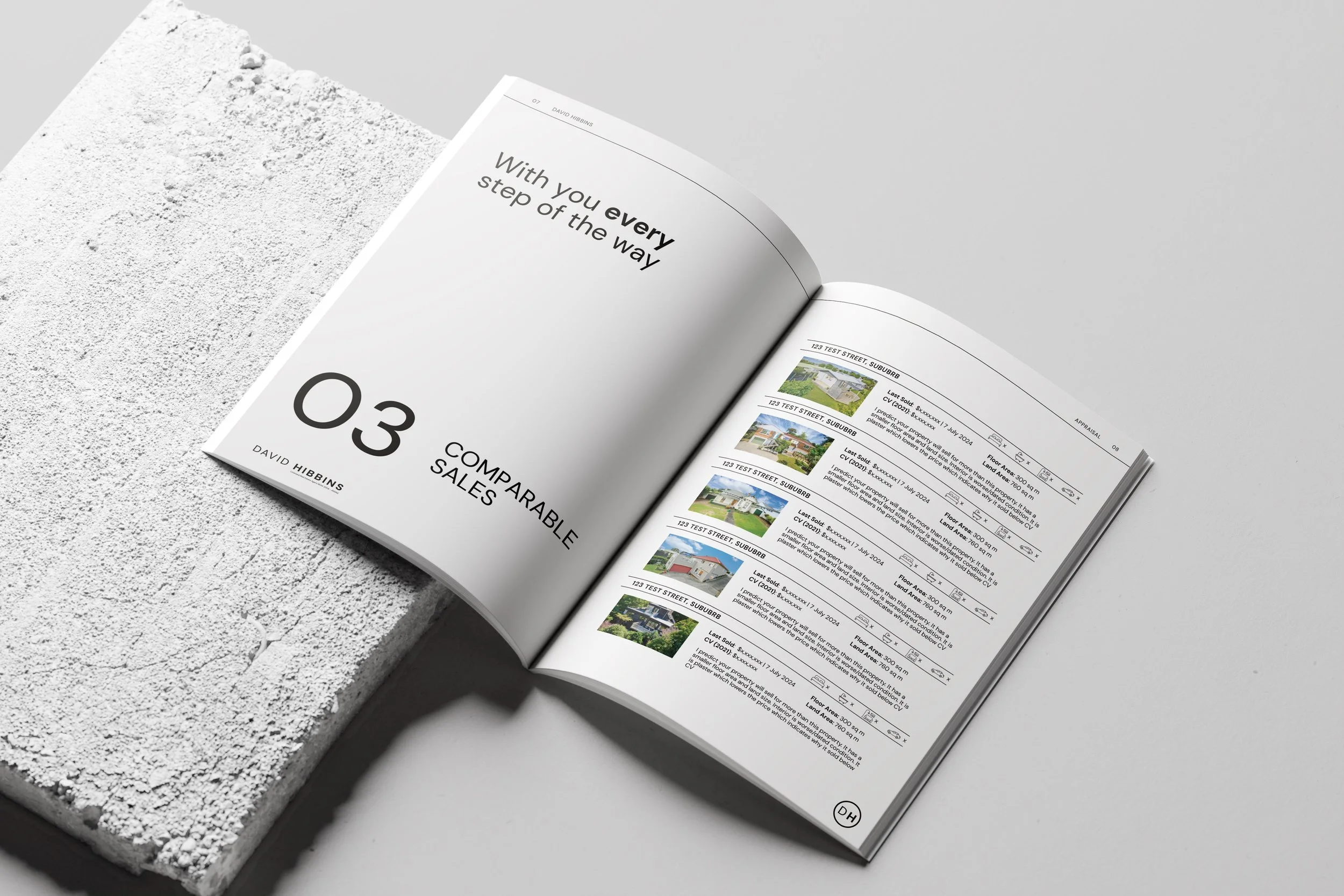 Open real estate catalog showing property listings on white background.
