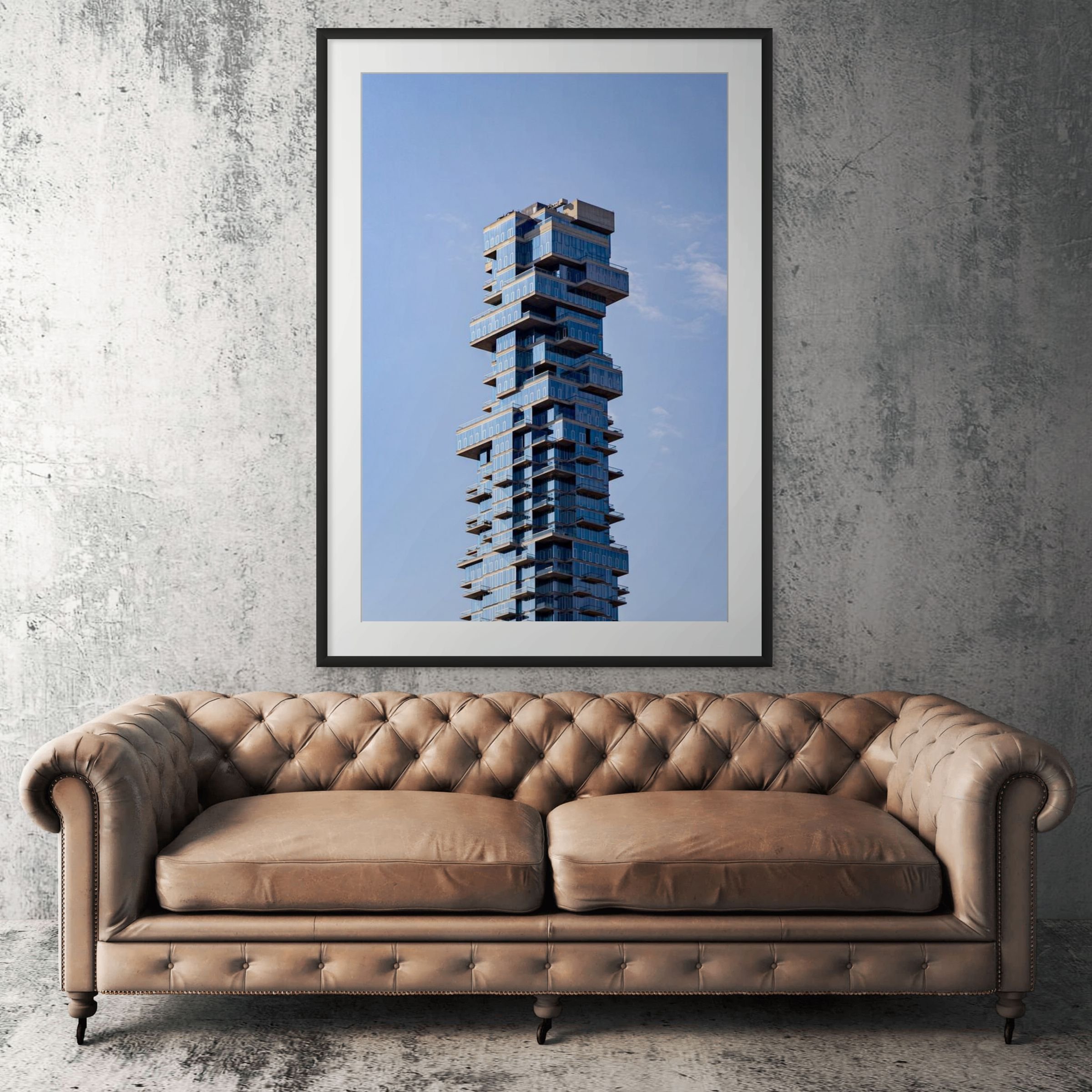 Manhattan architecture framed print displayed above tan leather sofa in living room (Copy)