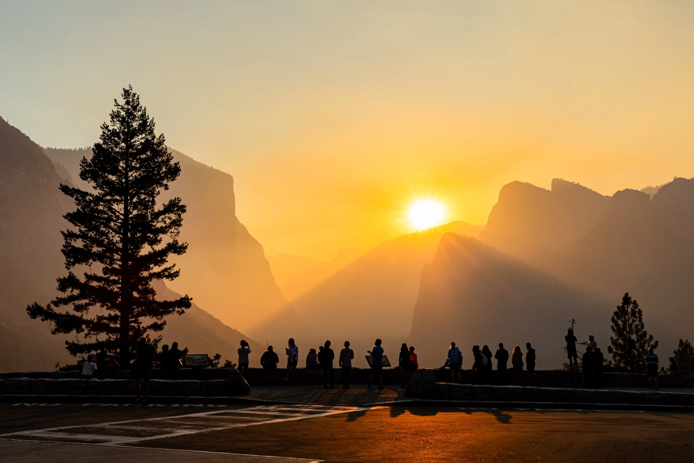 Sunrise watchers at Yosemite Tunnel View with El Capitan and golden light California