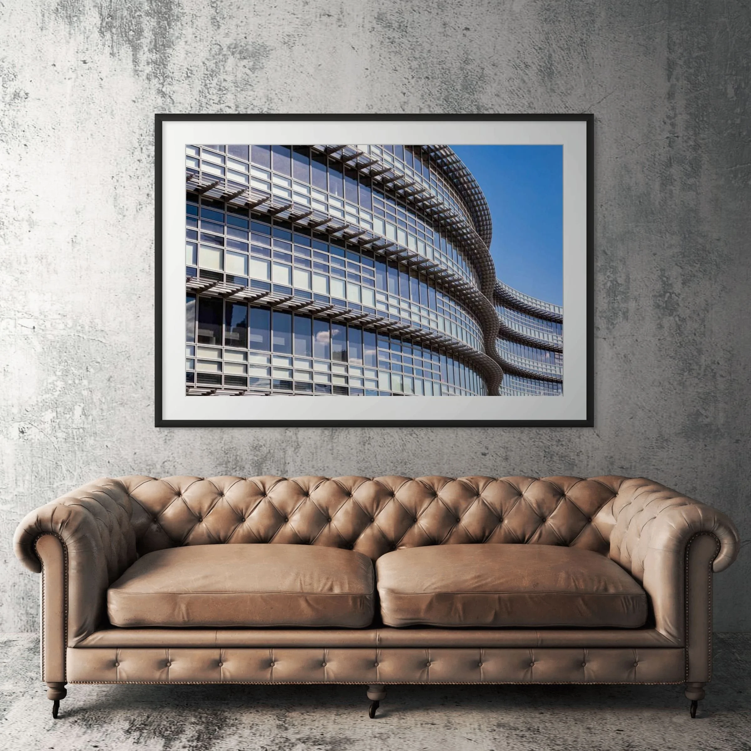 Pittsburgh Arconic Building framed print displayed above tan leather sofa in living room