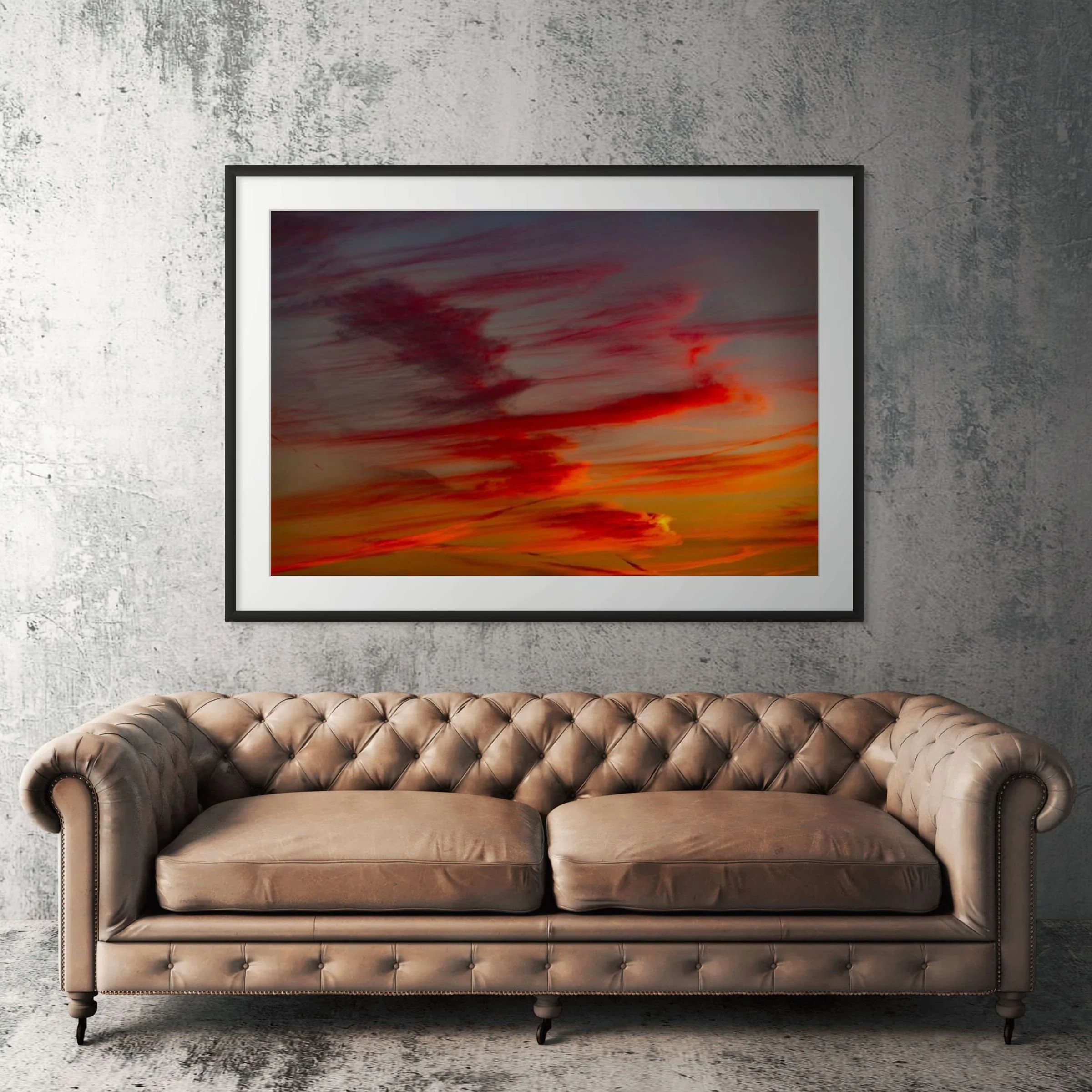 Sunset Hills cloud framed print displayed above tan leather sofa in living room