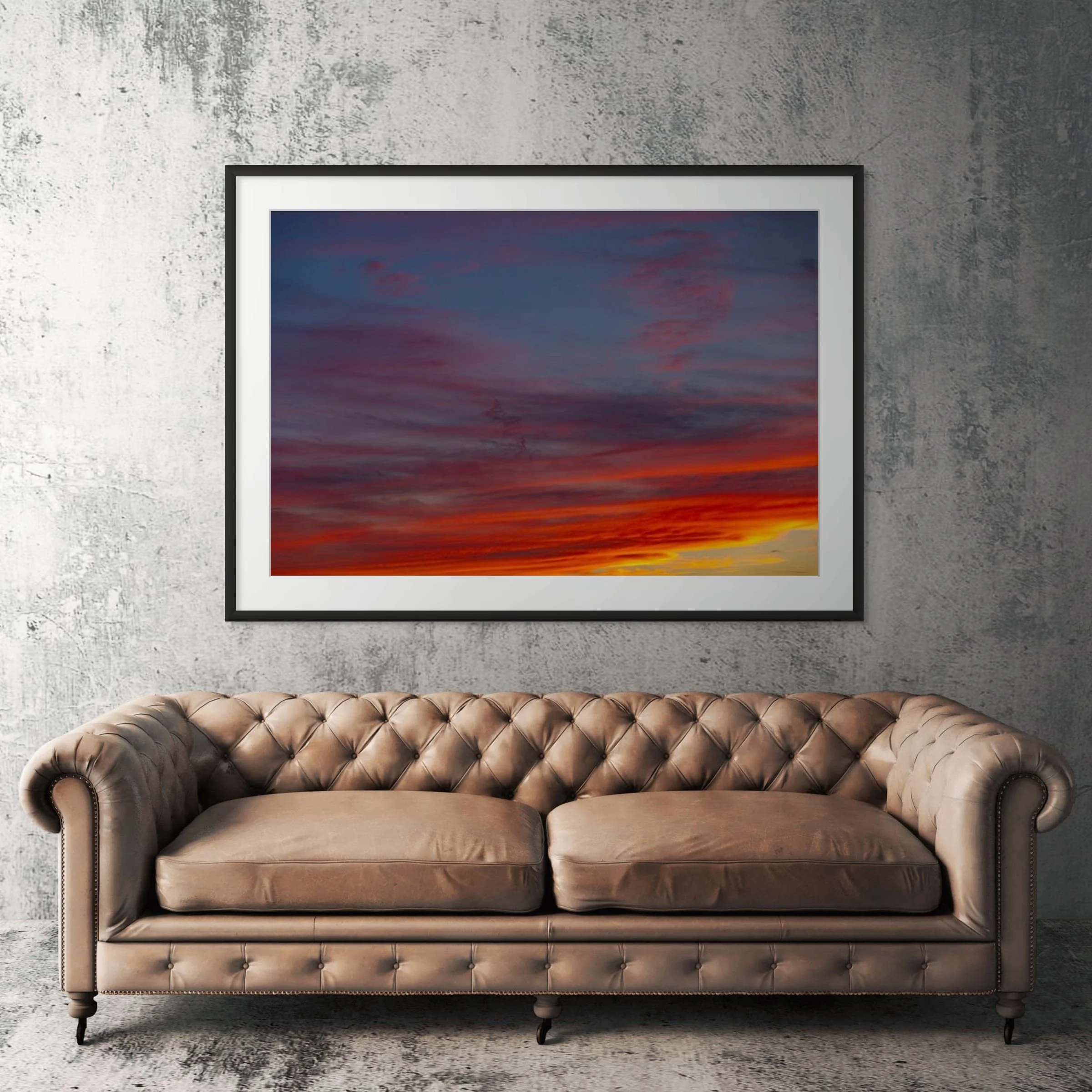 Sunset Hills layered clouds framed print displayed above tan leather sofa in living room