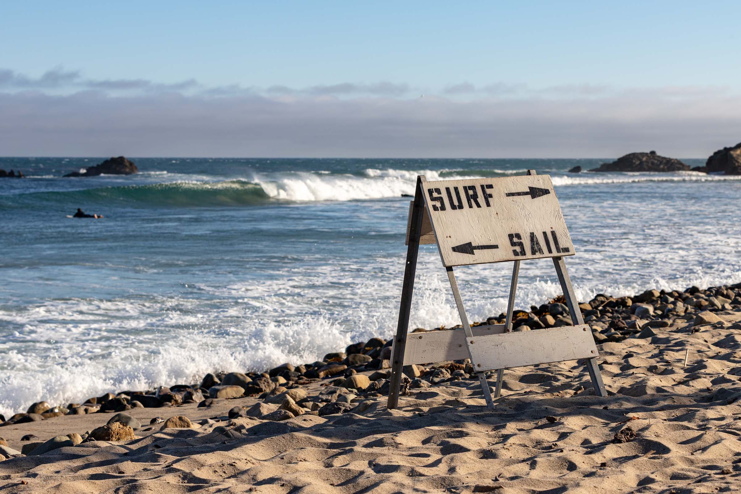 Vintage surf or sail weathered sign on Malibu beach with ocean view California