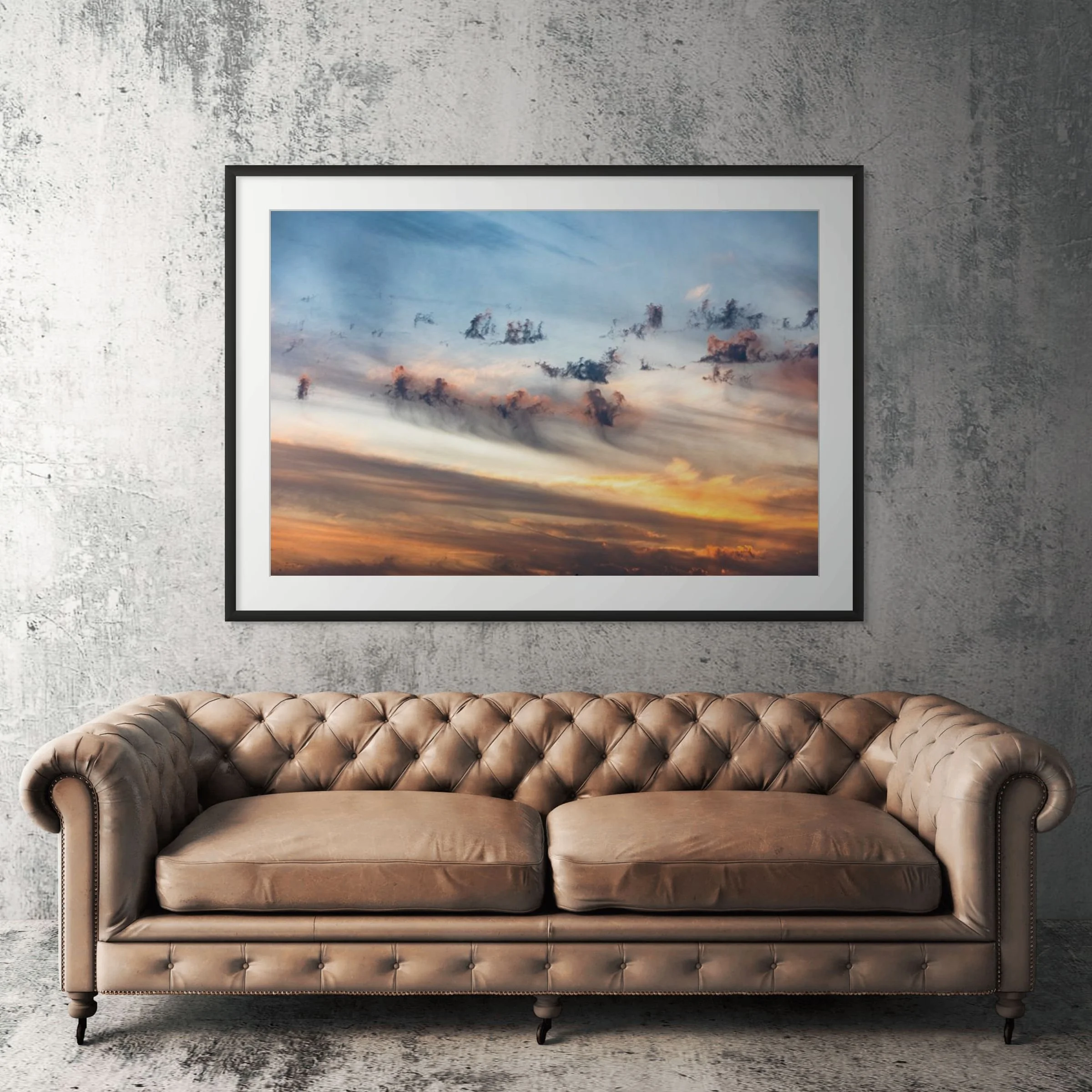 Sunset Hills abstract clouds framed print displayed above tan leather sofa in living room
