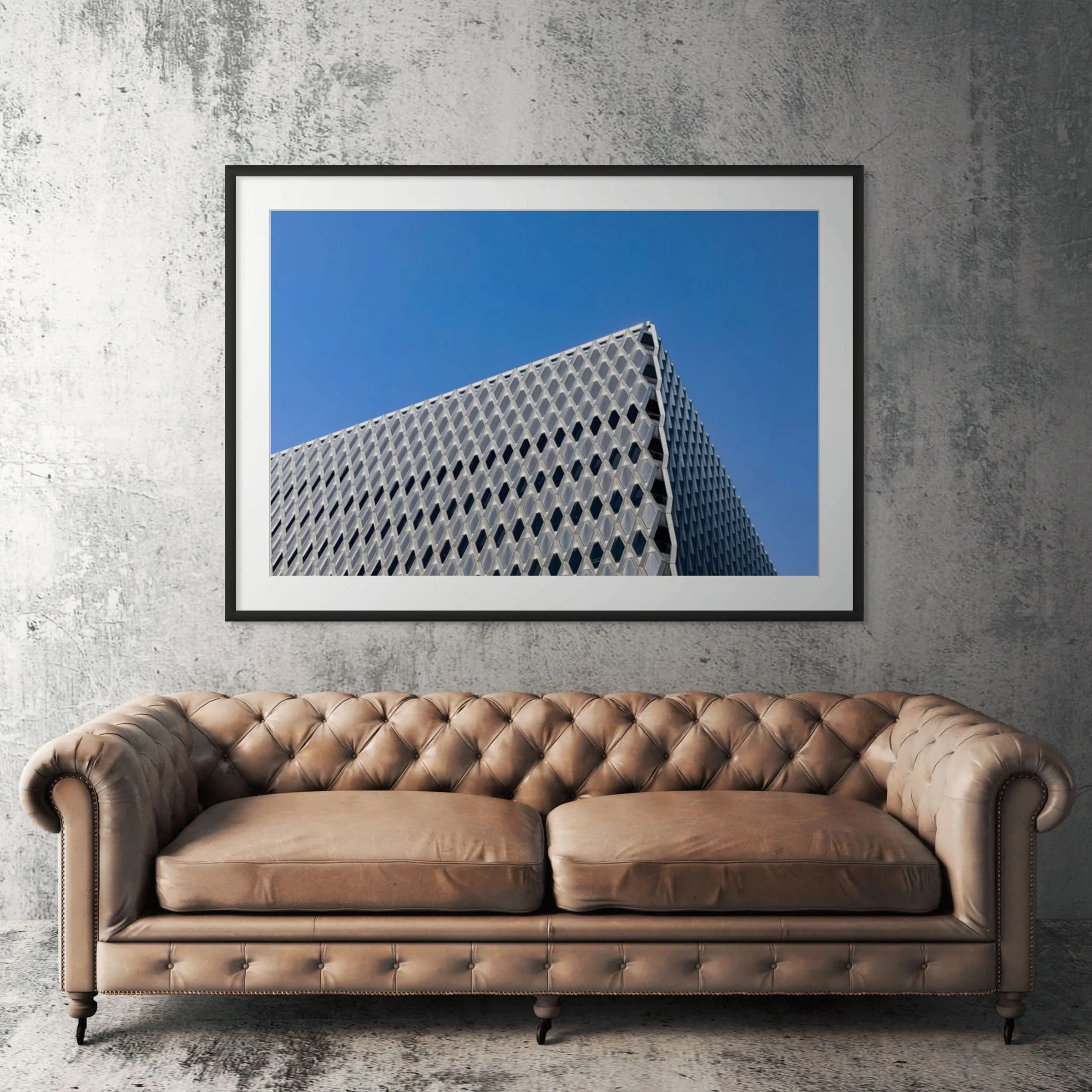 Pittsburgh Steelworkers Building framed print displayed above tan leather sofa in living room