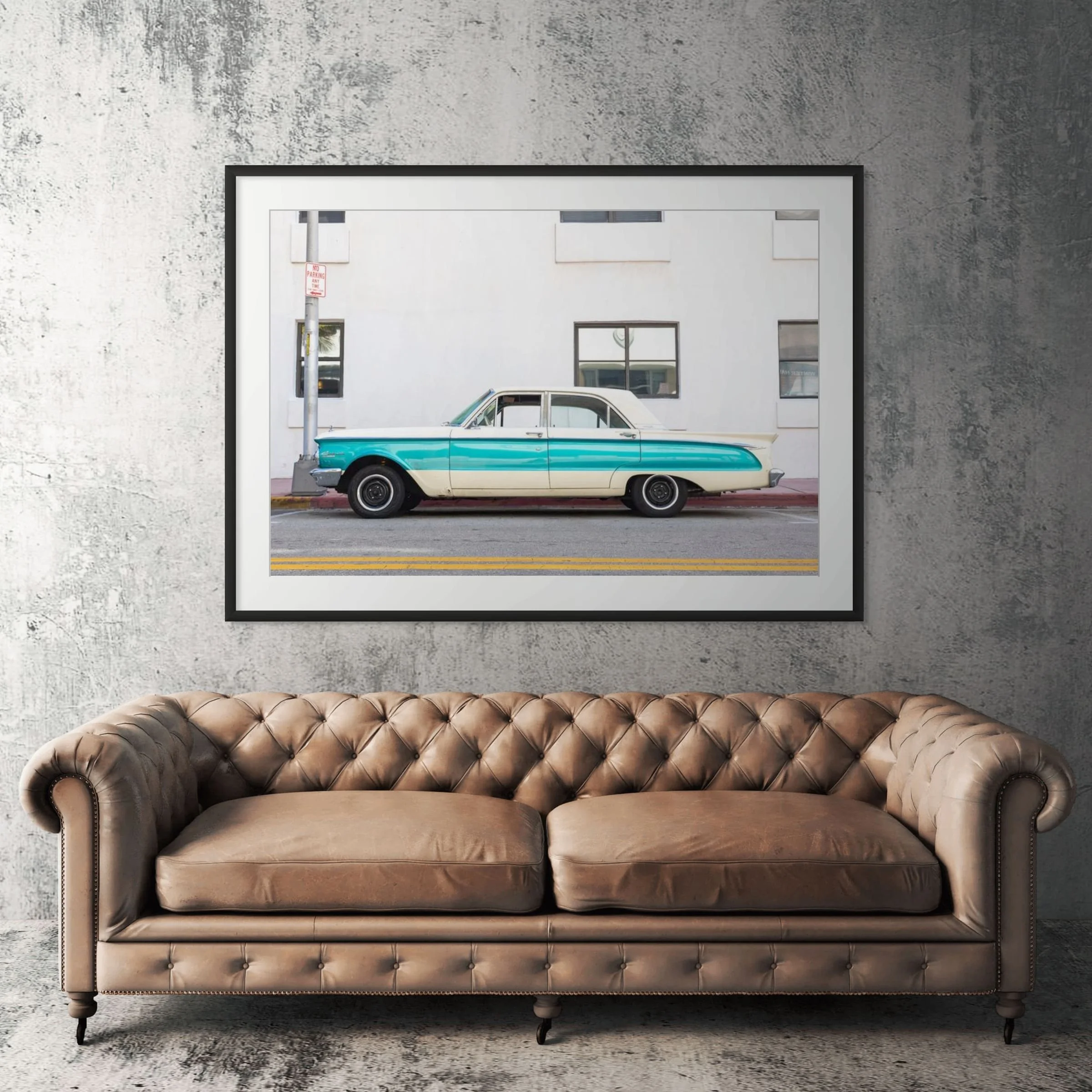 Miami Beach vintage car framed print displayed above tan leather sofa in living room