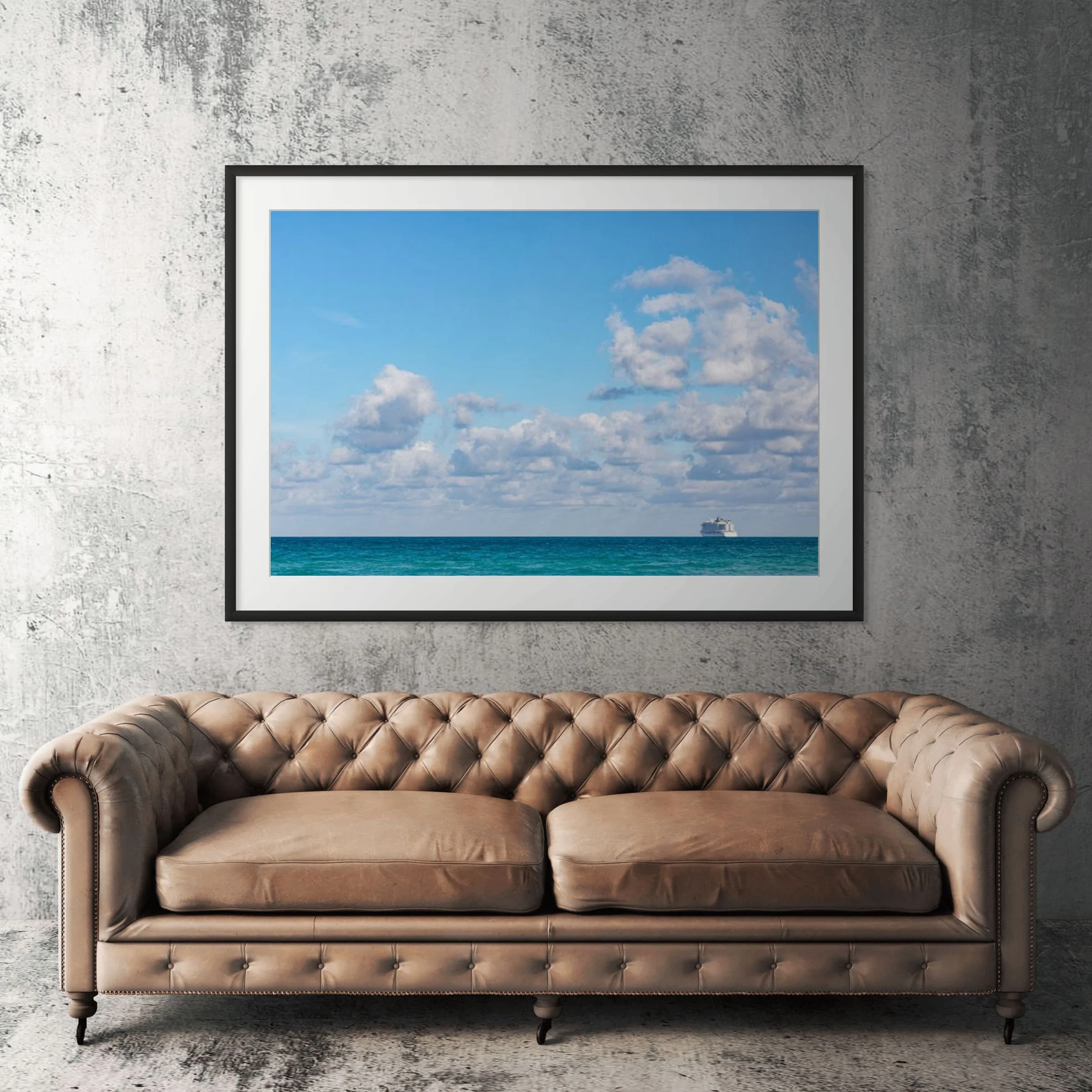 Miami Beach ocean horizon framed print displayed above tan leather sofa in living room