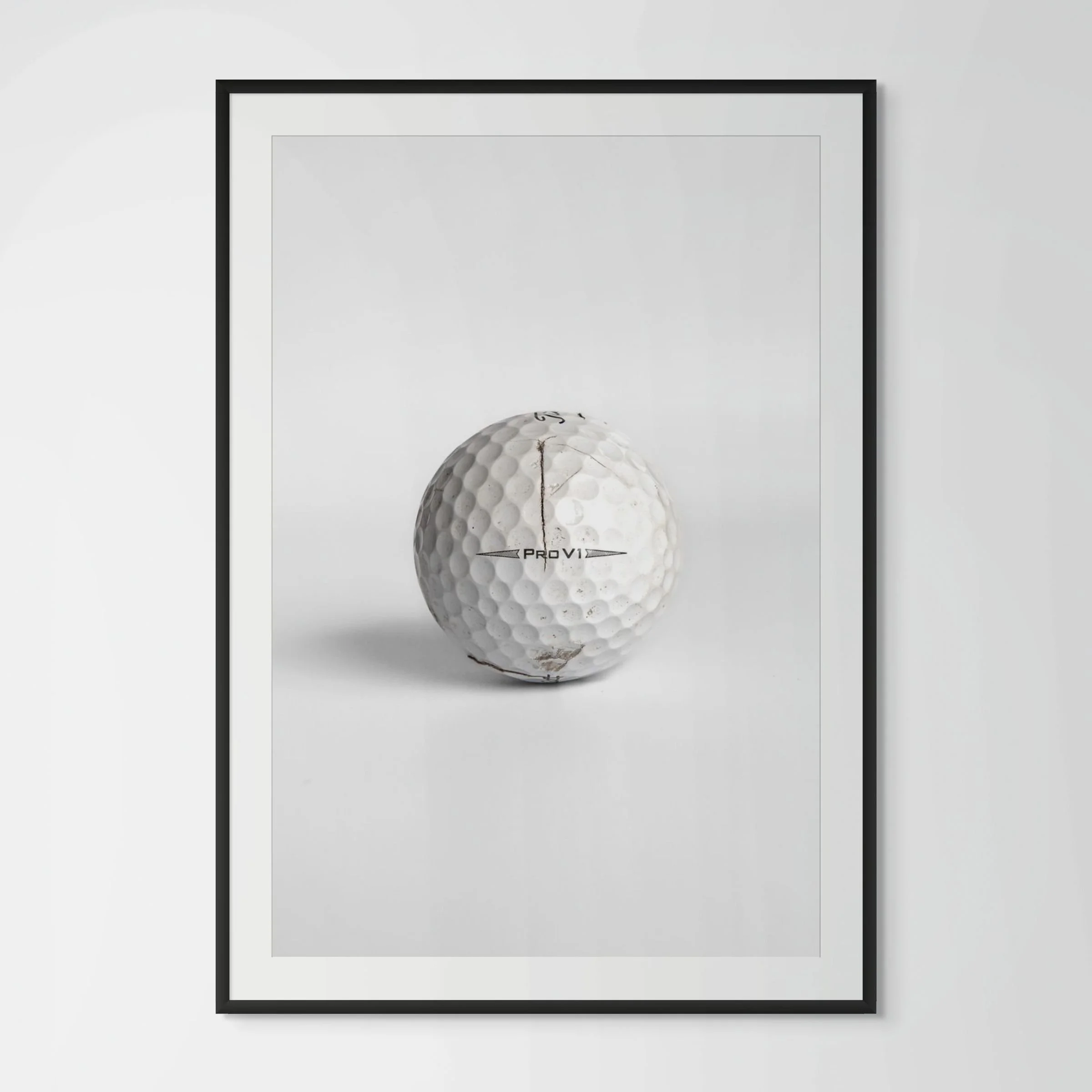 Titleist Pro V1 split golf ball framed photography print in black wood frame