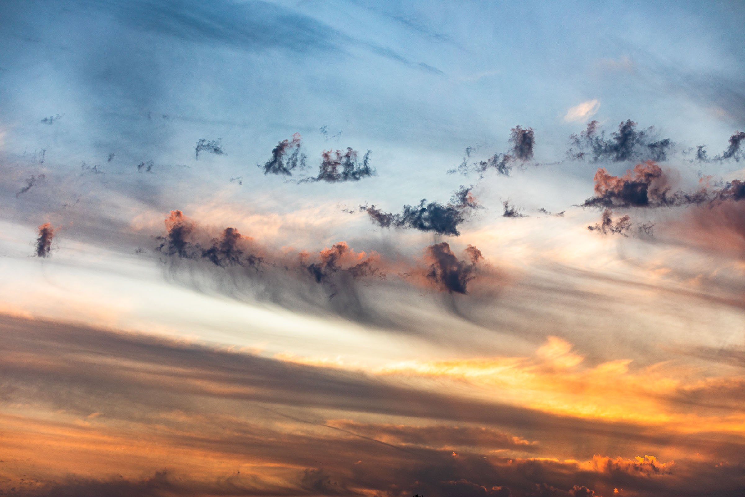 Abstract clouds in blue and yellow twilight creating minimalist landscape over Sunset Hills
