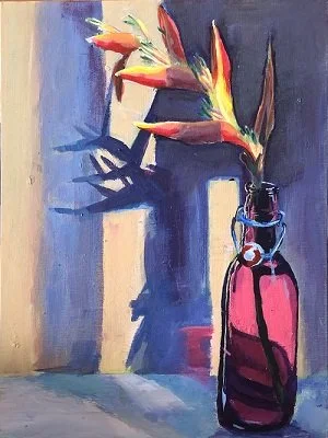 A bouquet of flowers in a pink bottle on a table with a shadow cast against a textured wall.