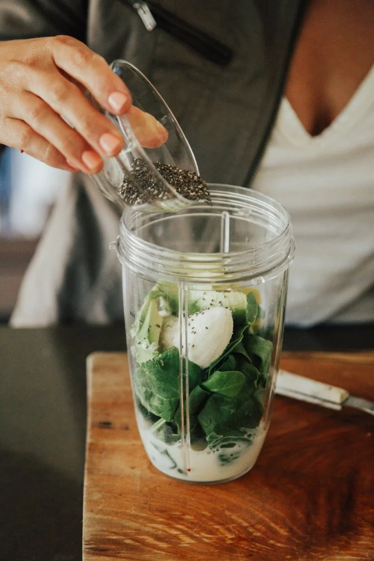 Lia making a healthy green smoothie with foods to help reduce stress and improve mood.