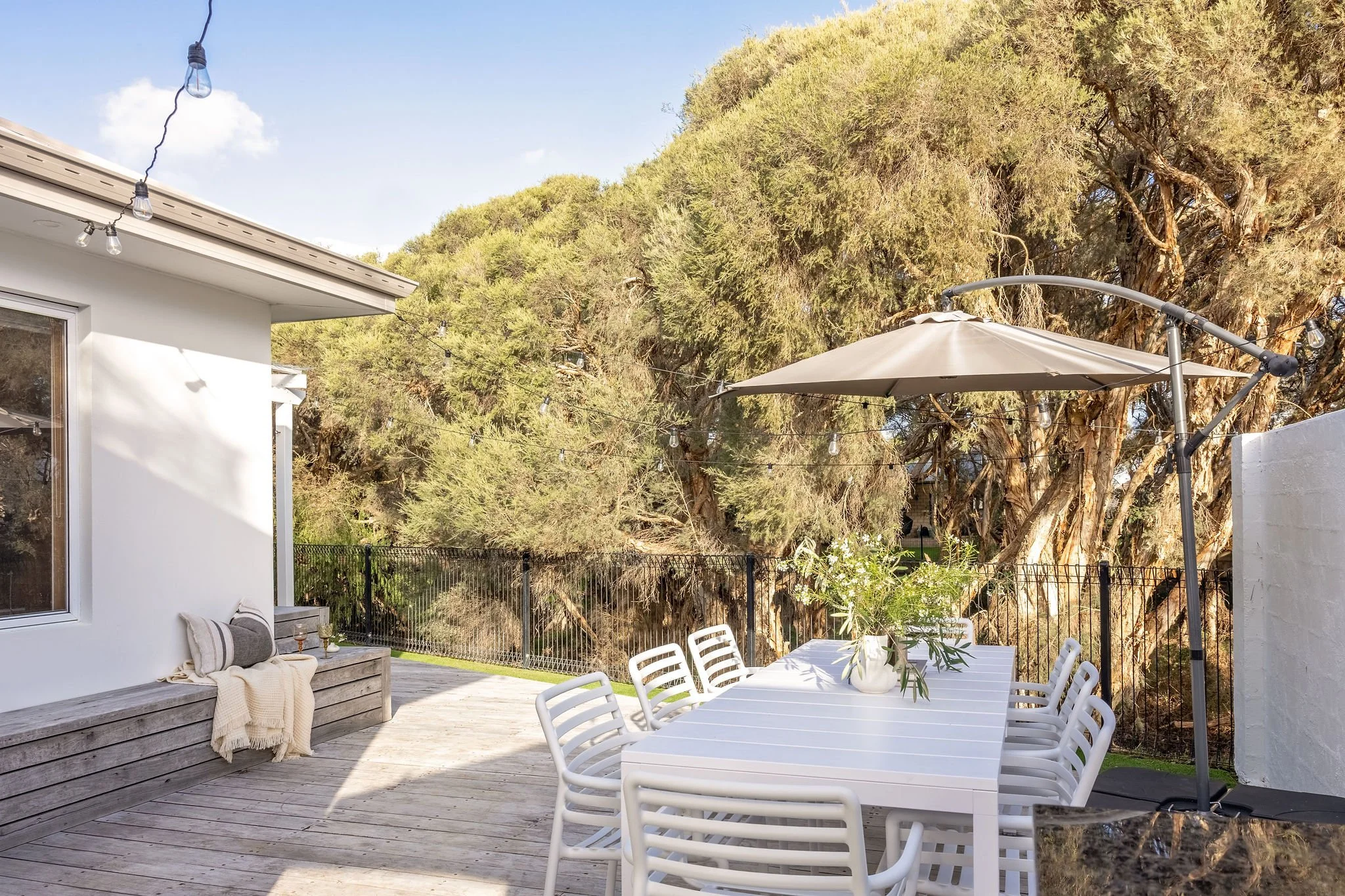 Alfresco dining wraps around the house with umbrella shade, Seastream Haven Dunsborough