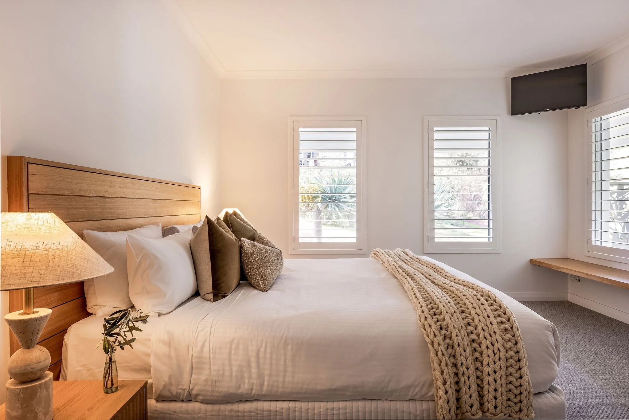 Master bedroom with plantation shutters and wall-mounted Smart TV, Seastream Haven Dunsborough