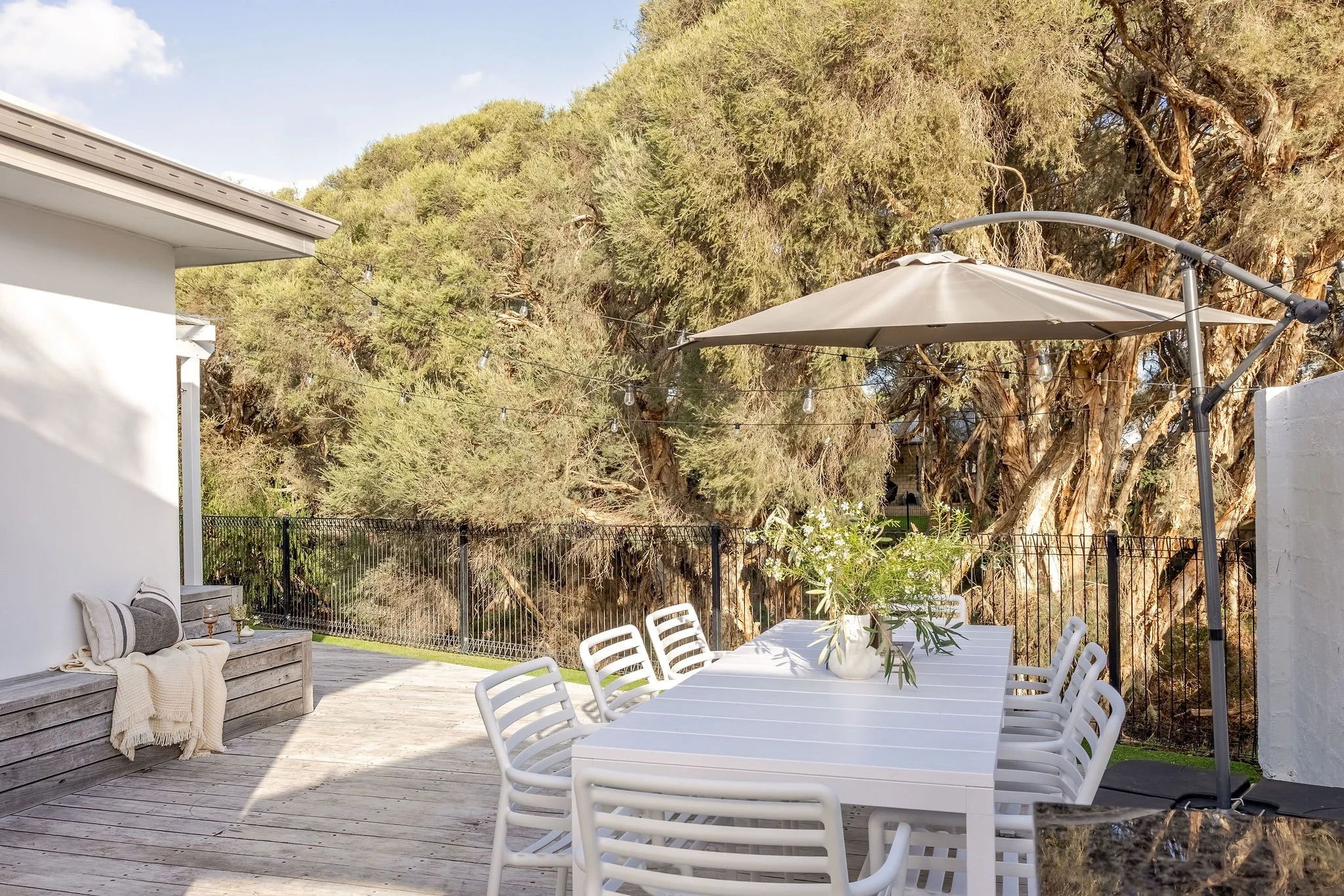 Large timber deck with shade umbrella beside the bushland, Seastream Haven Dunsborough